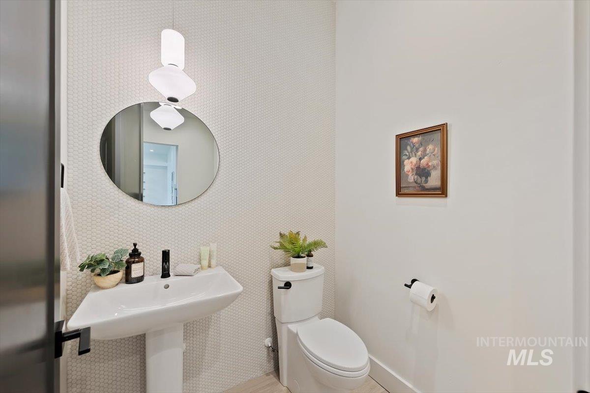 Bathroom with toilet and baseboards