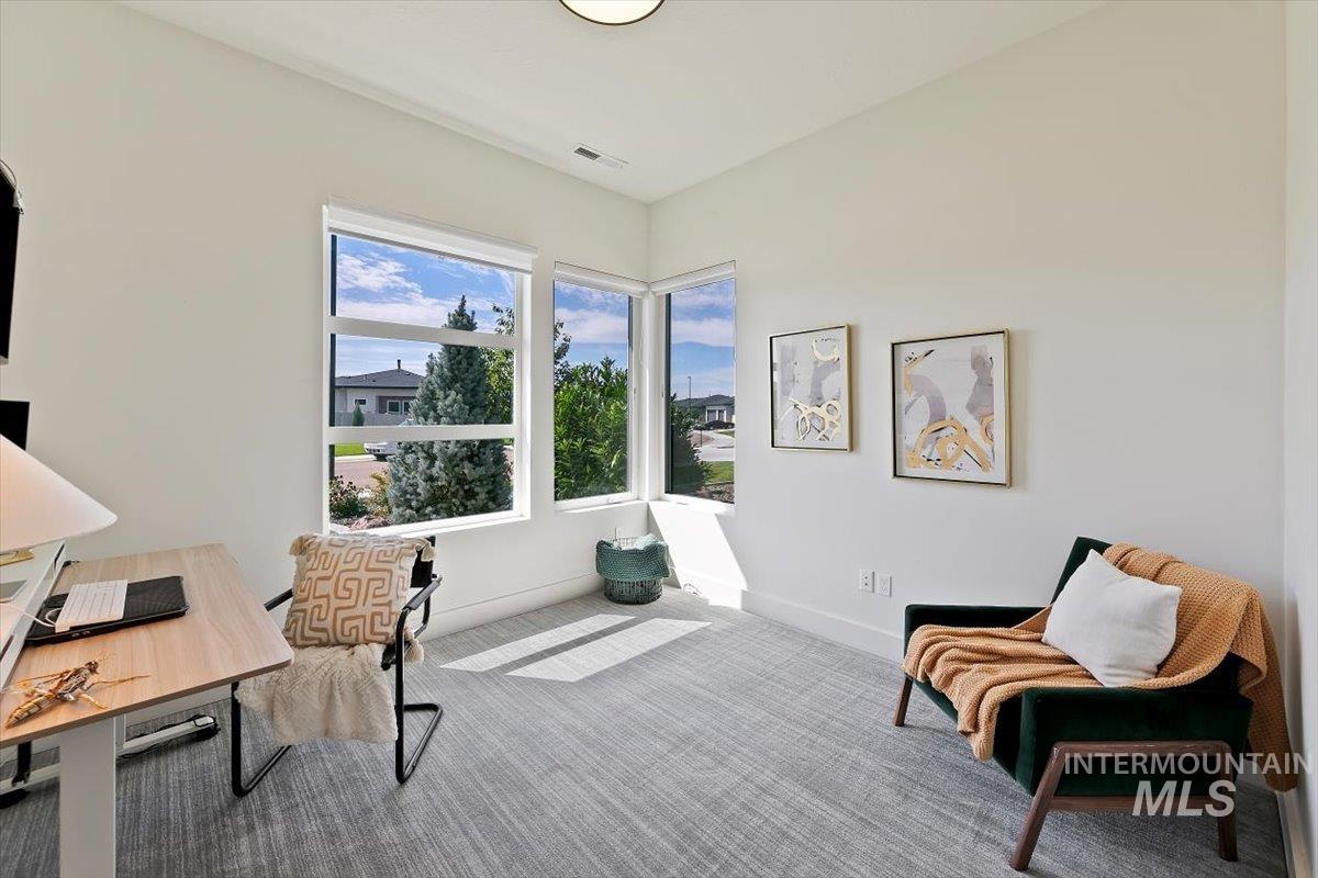 Home office with carpet flooring and baseboards
