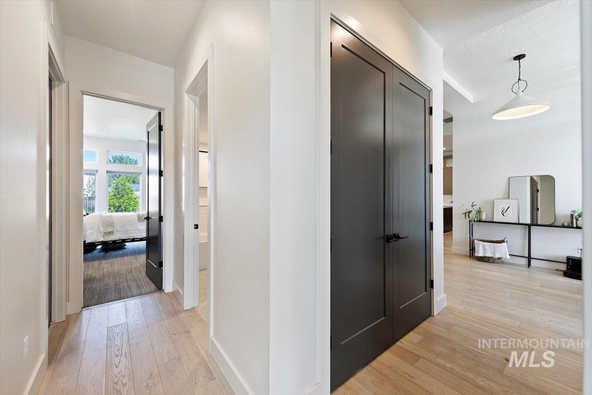 Hallway featuring light wood finished floors and baseboards