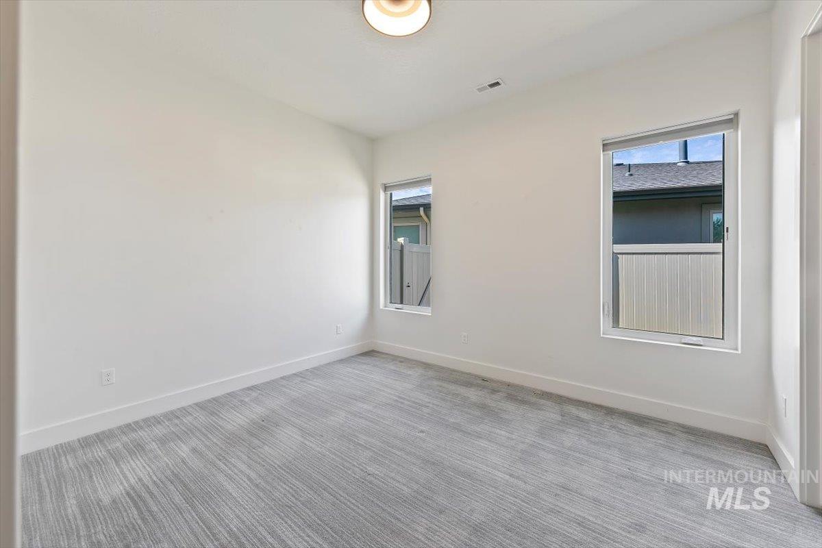 Empty room with carpet and baseboards