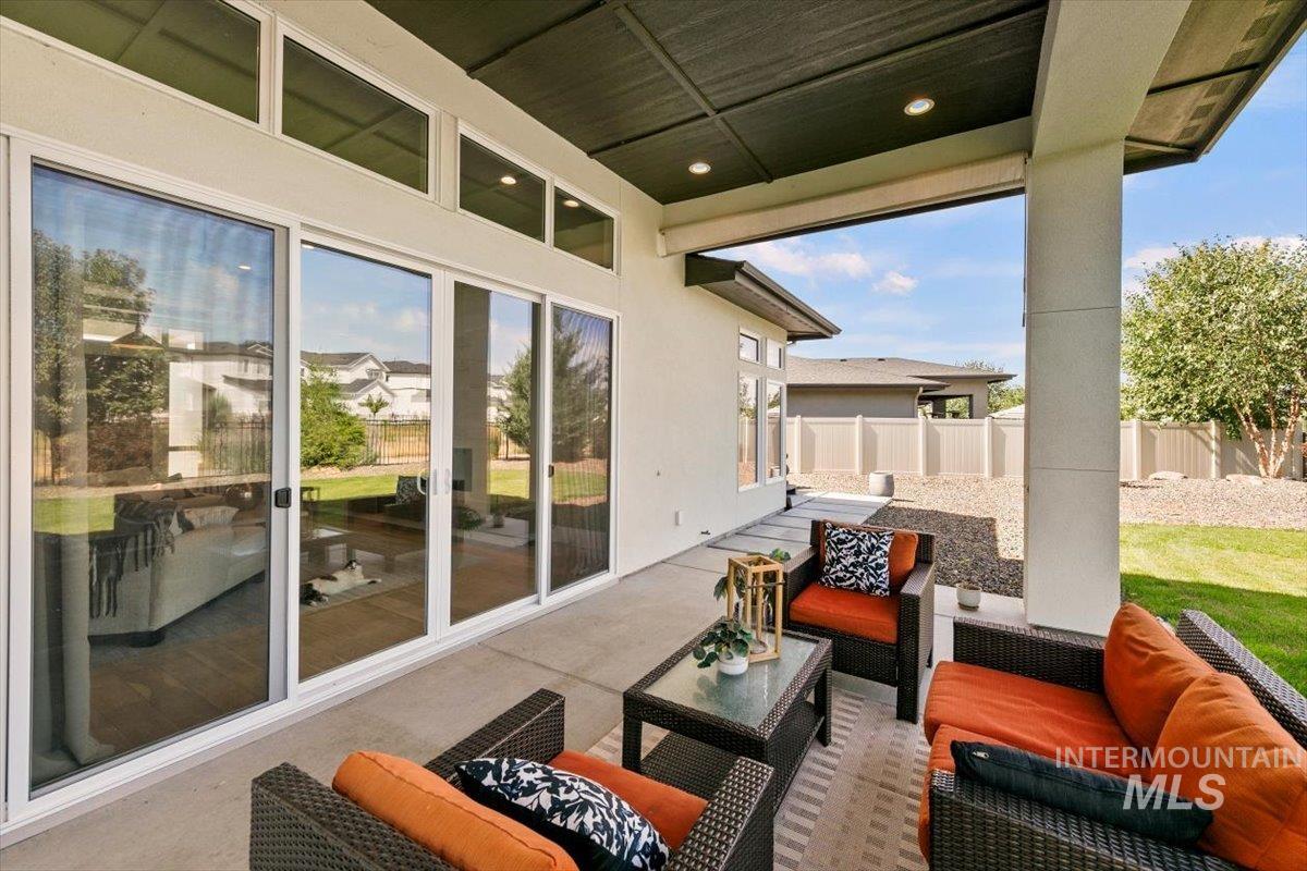Fenced backyard featuring a patio area and an outdoor living space