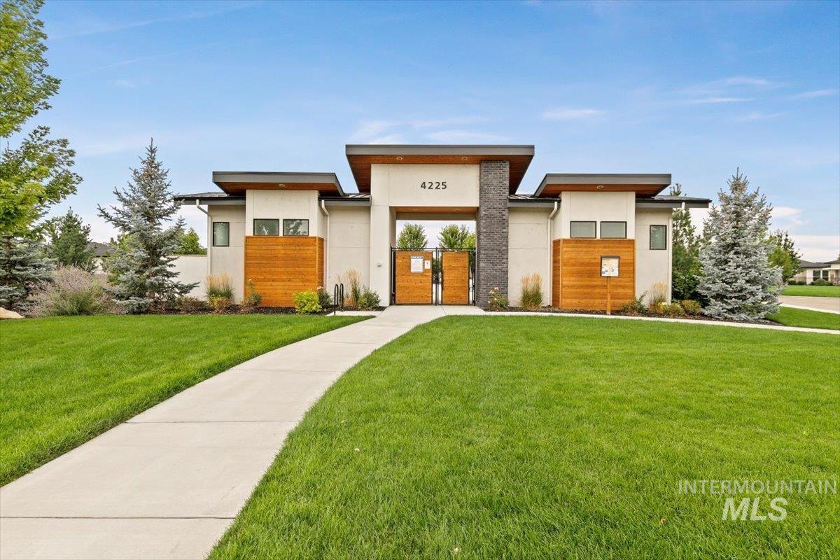 Modern home with a front yard and stucco siding