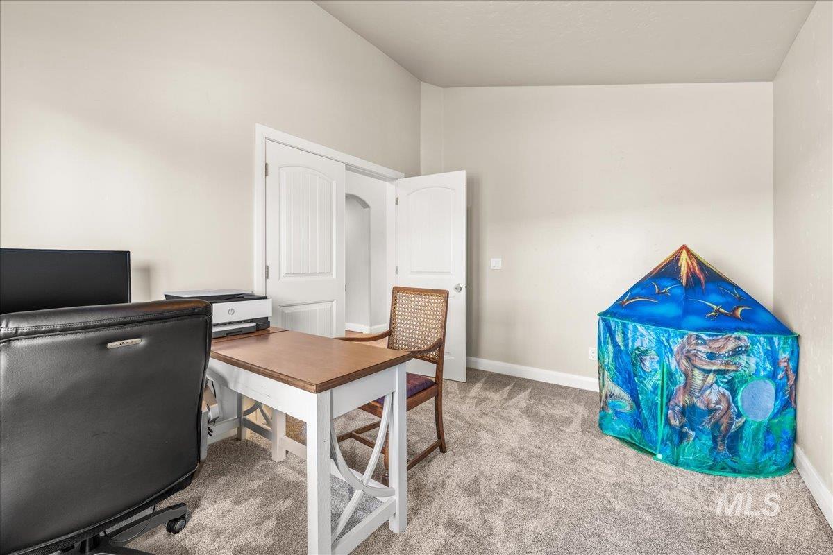 Office space featuring light carpet and baseboards