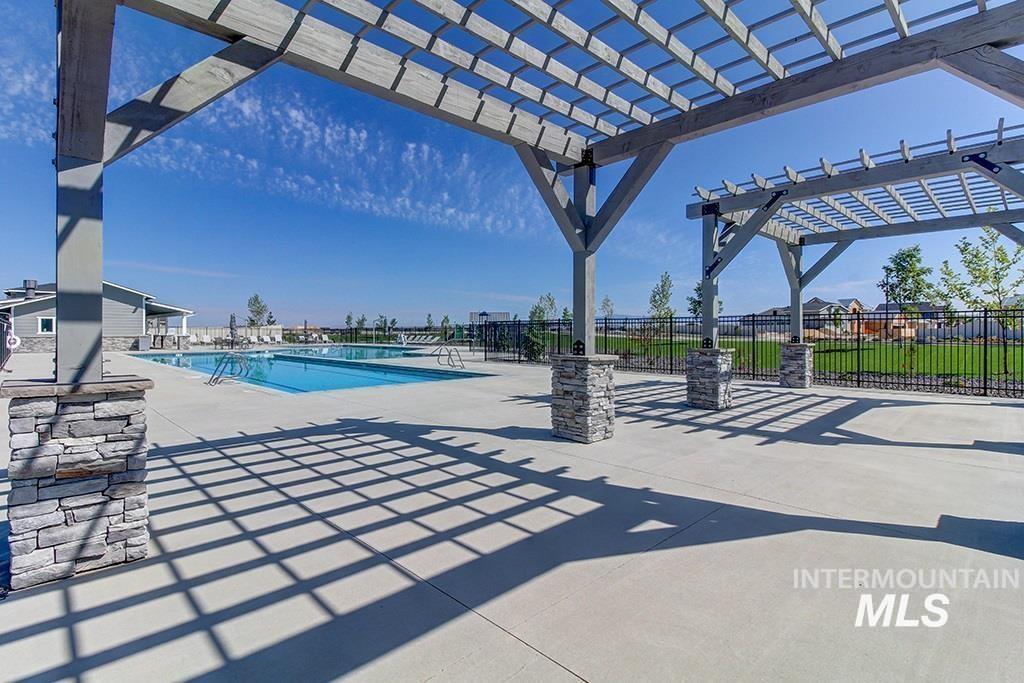 Community pool featuring a patio area and a pergola