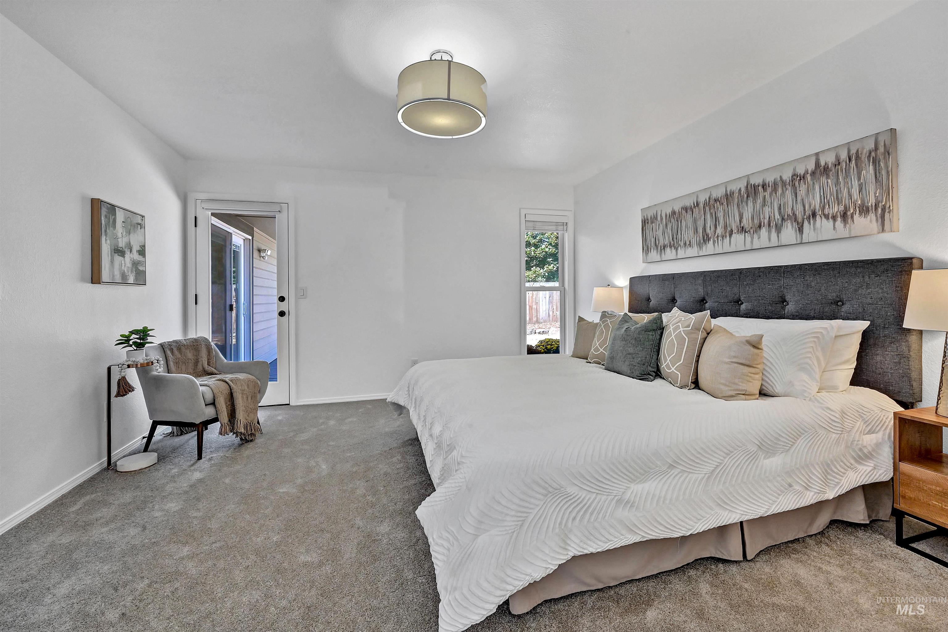 Bedroom featuring carpet floors and baseboards