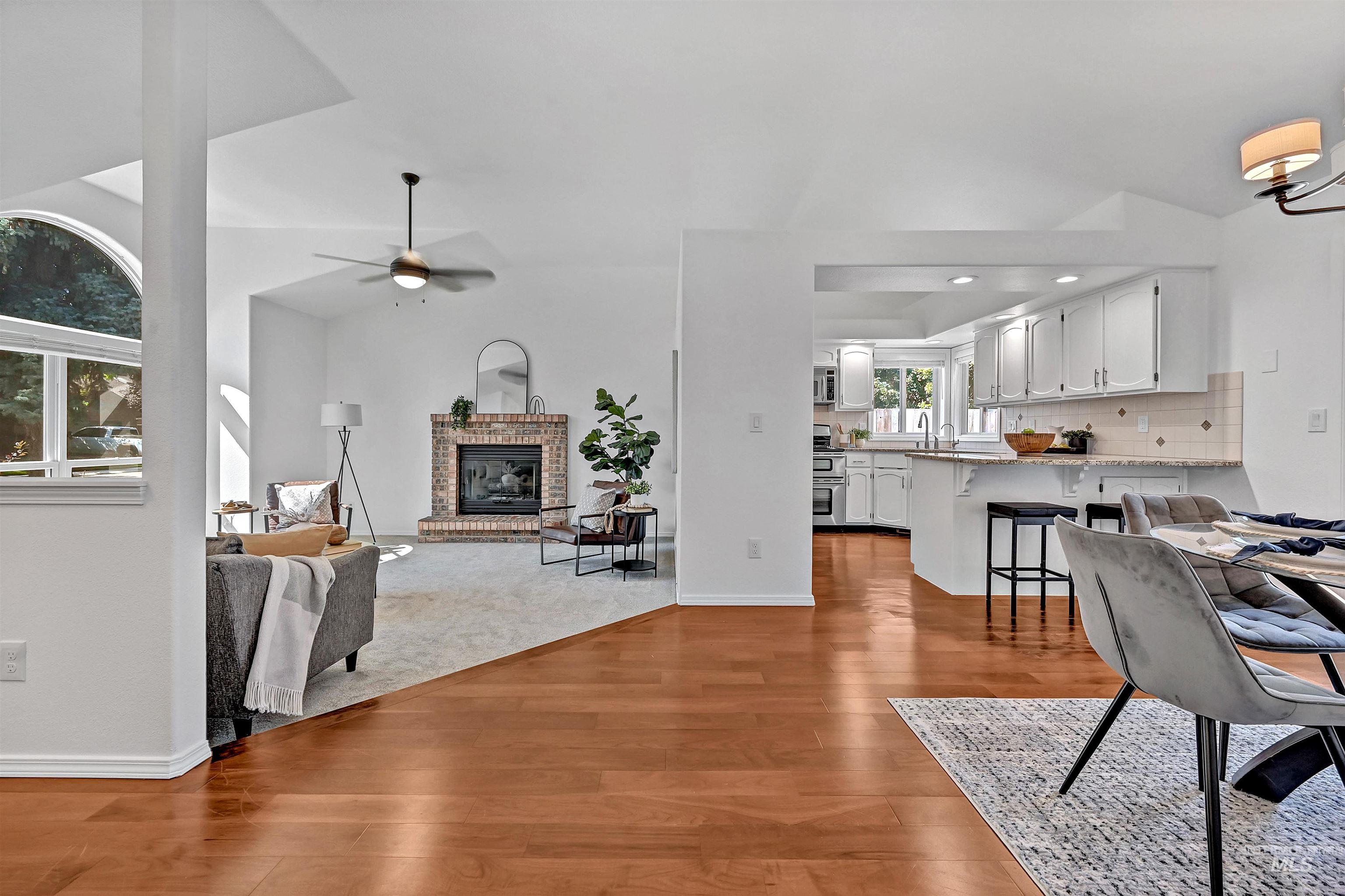 Dining space featuring a fireplace, light wood-style flooring, ceiling fan, and recessed lighting