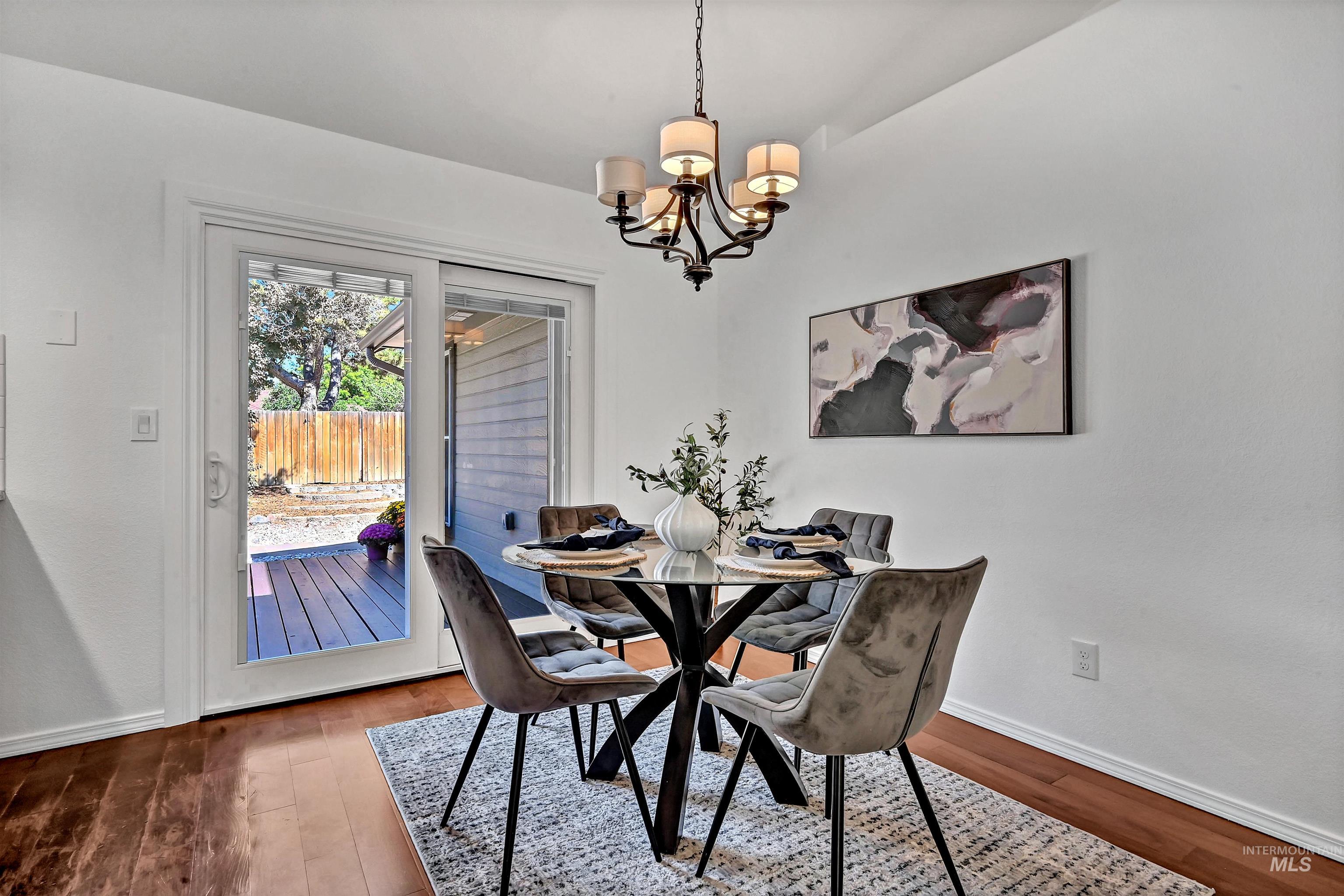 Dining area with a chandelier and dark wood finished floors