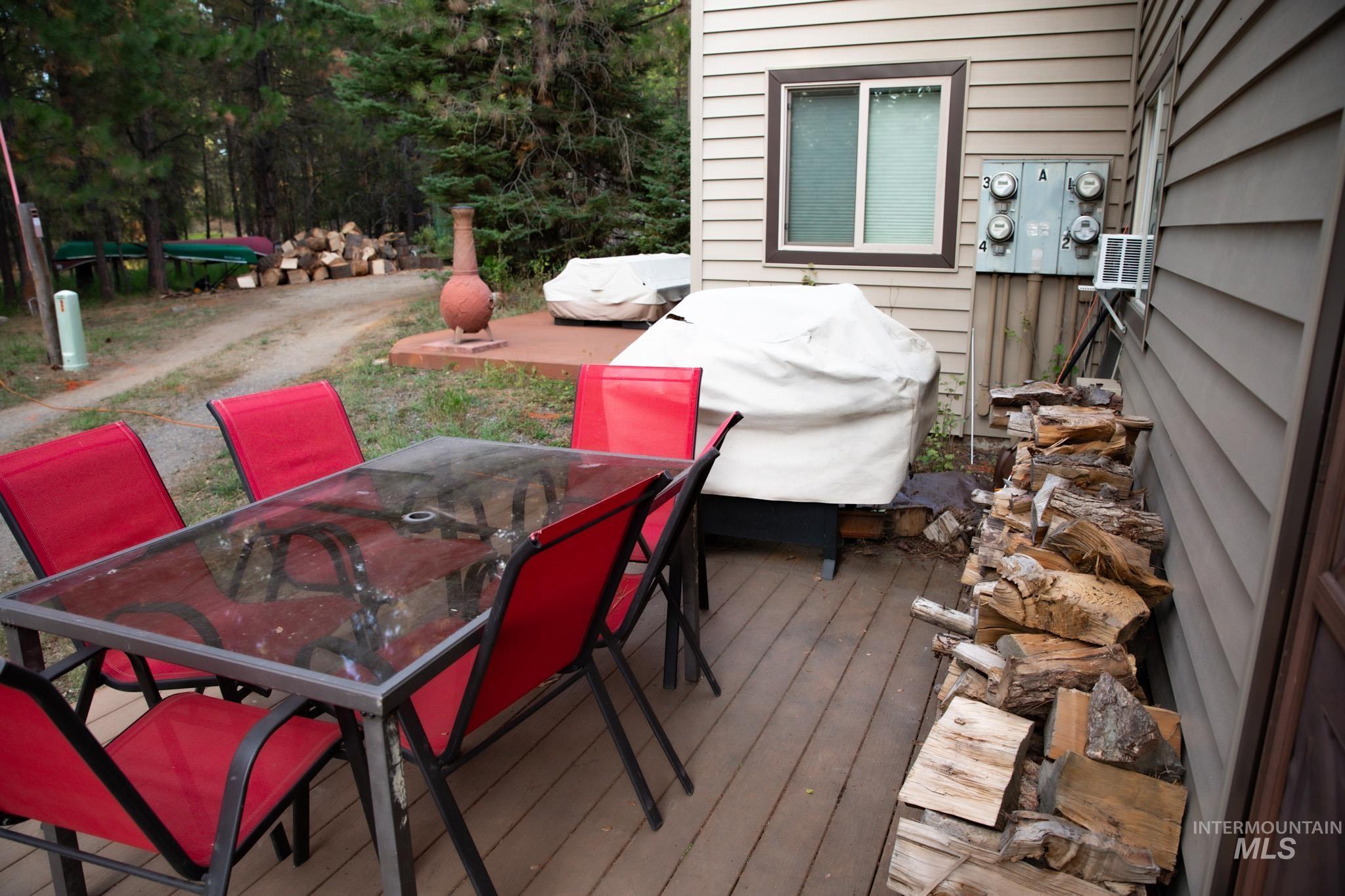 Wooden deck featuring outdoor dining area and a grill