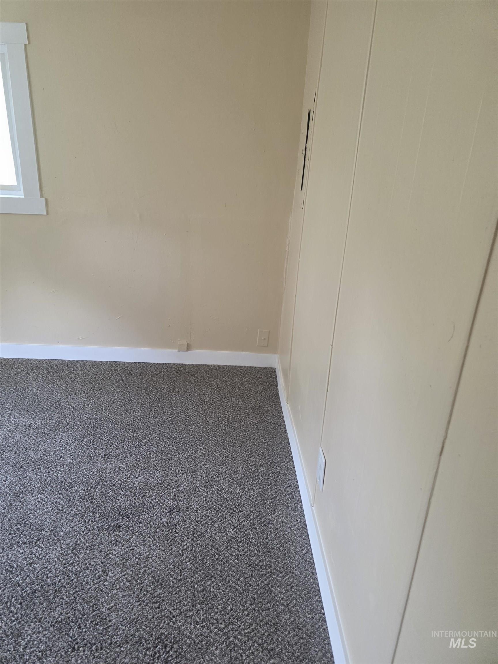 Unfurnished bedroom with baseboards and carpet floors