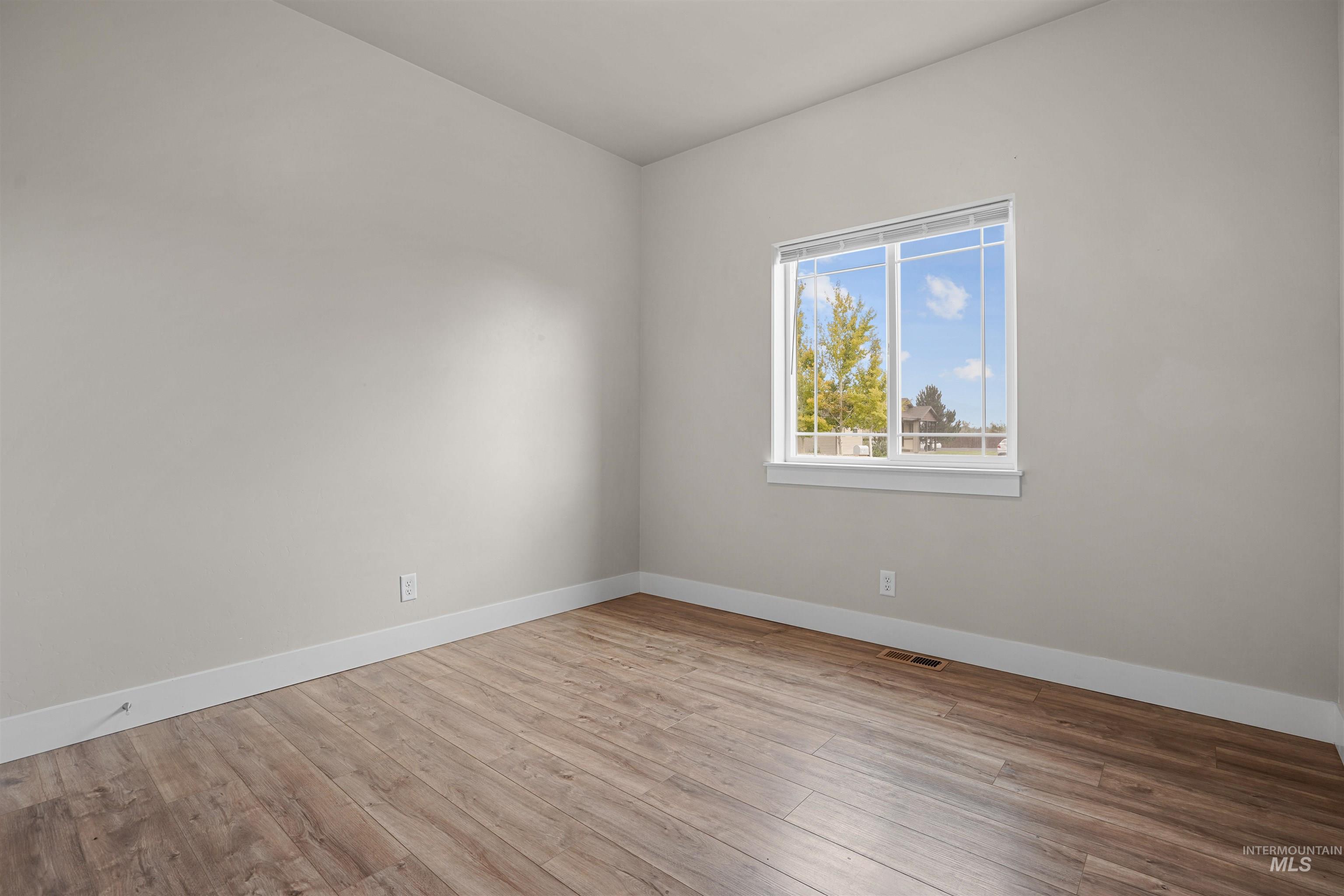 Empty room featuring light wood-type flooring
