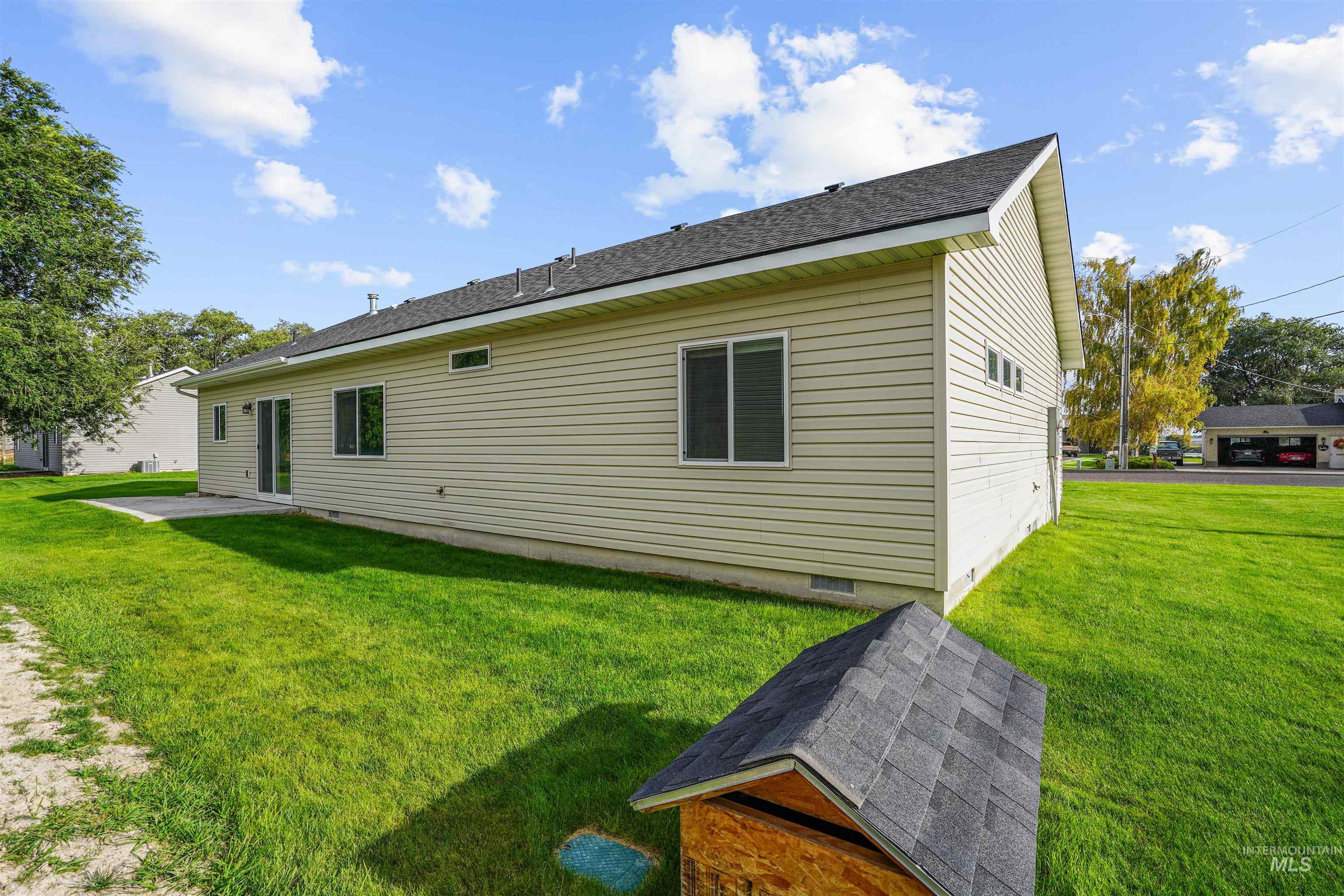 Back of property with a yard, a patio area, and crawl space
