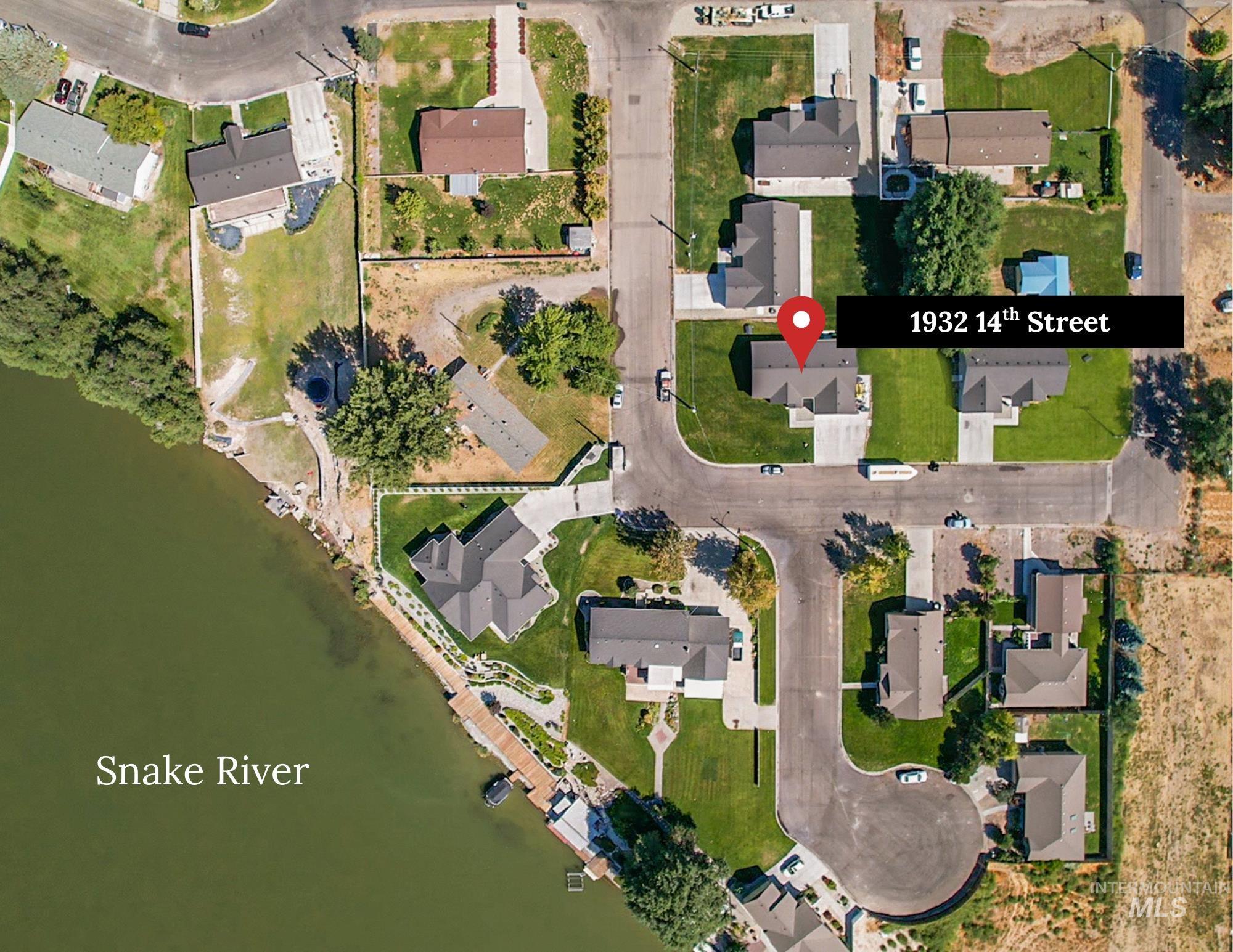 View of property location featuring nearby suburban area and a nearby body of water