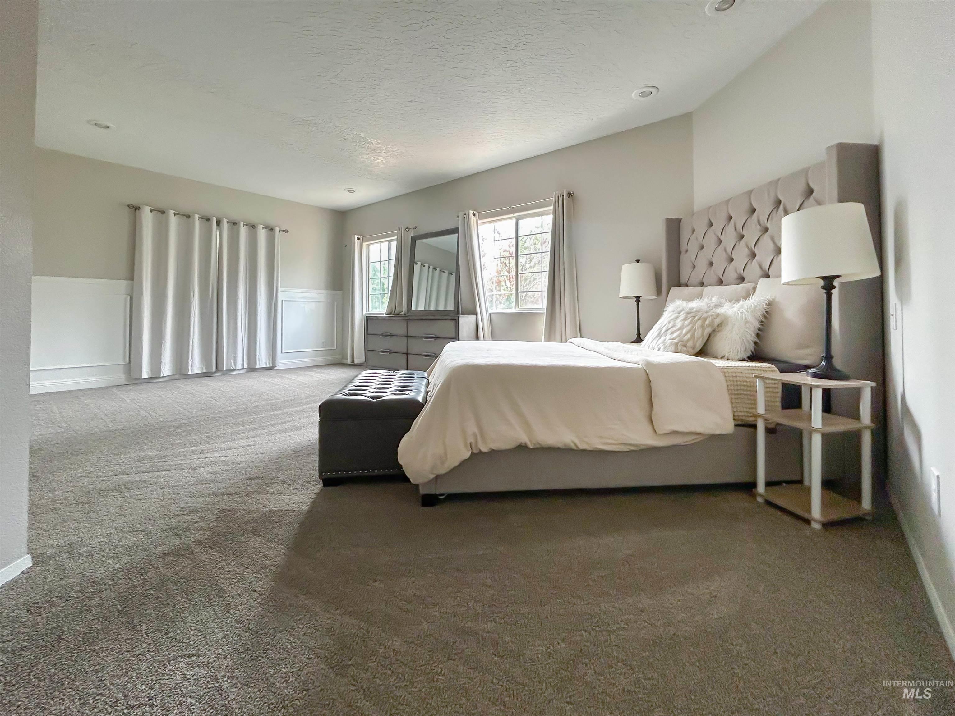 Carpeted bedroom with a textured ceiling