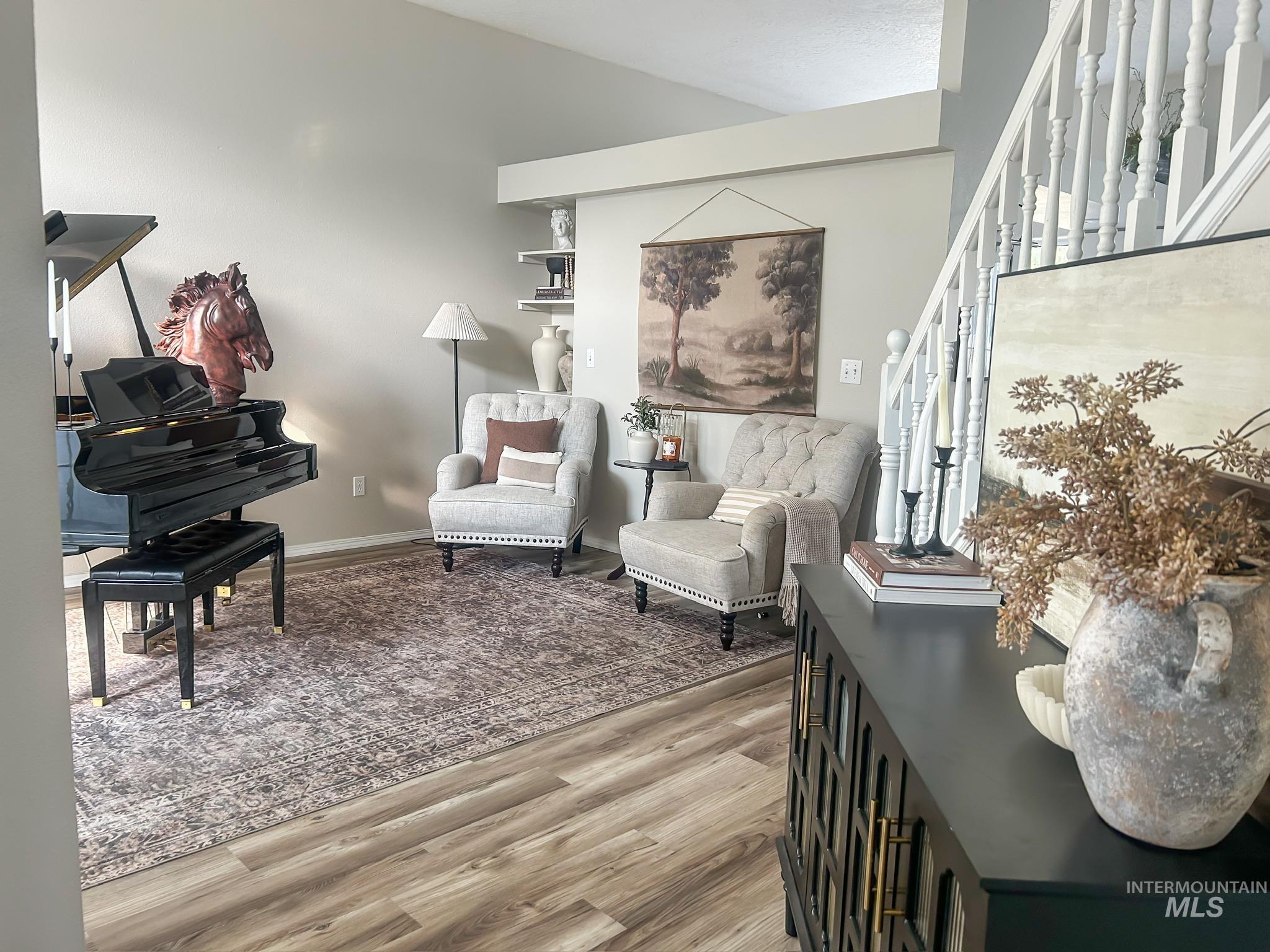 Living area featuring light wood-type flooring and stairway