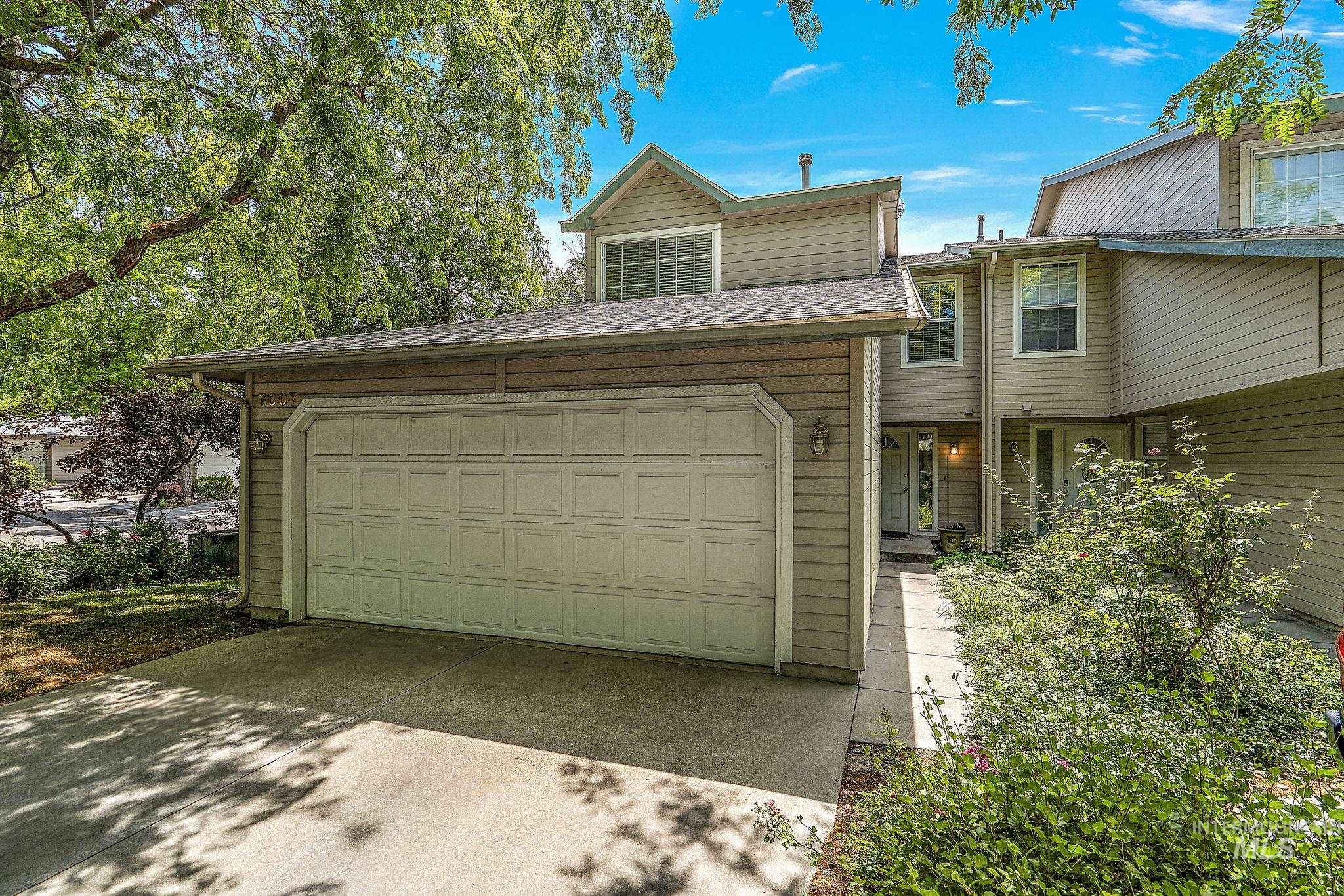 View of front of home with driveway and a garage