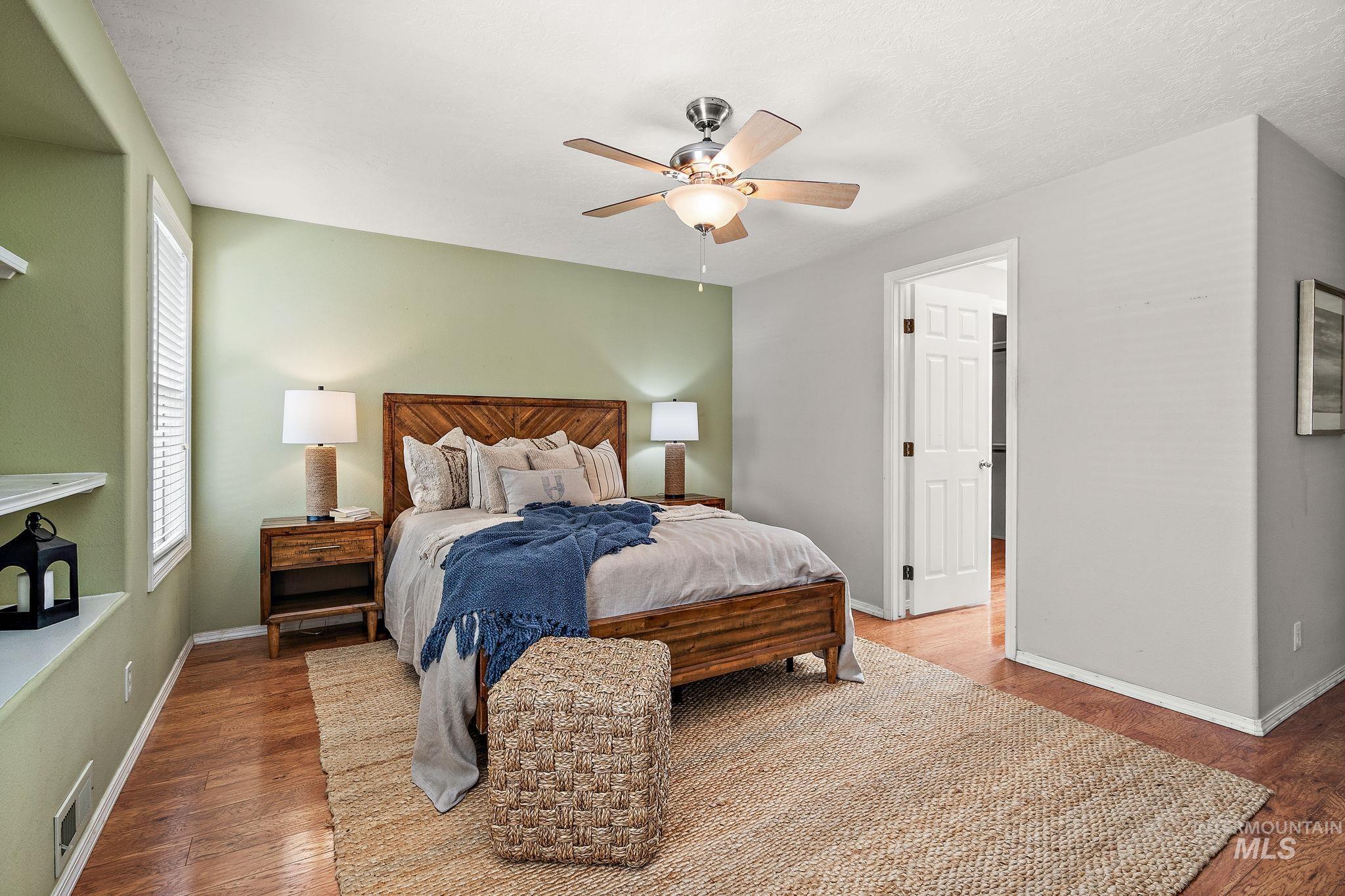 Bedroom featuring wood finished floors and ceiling fan