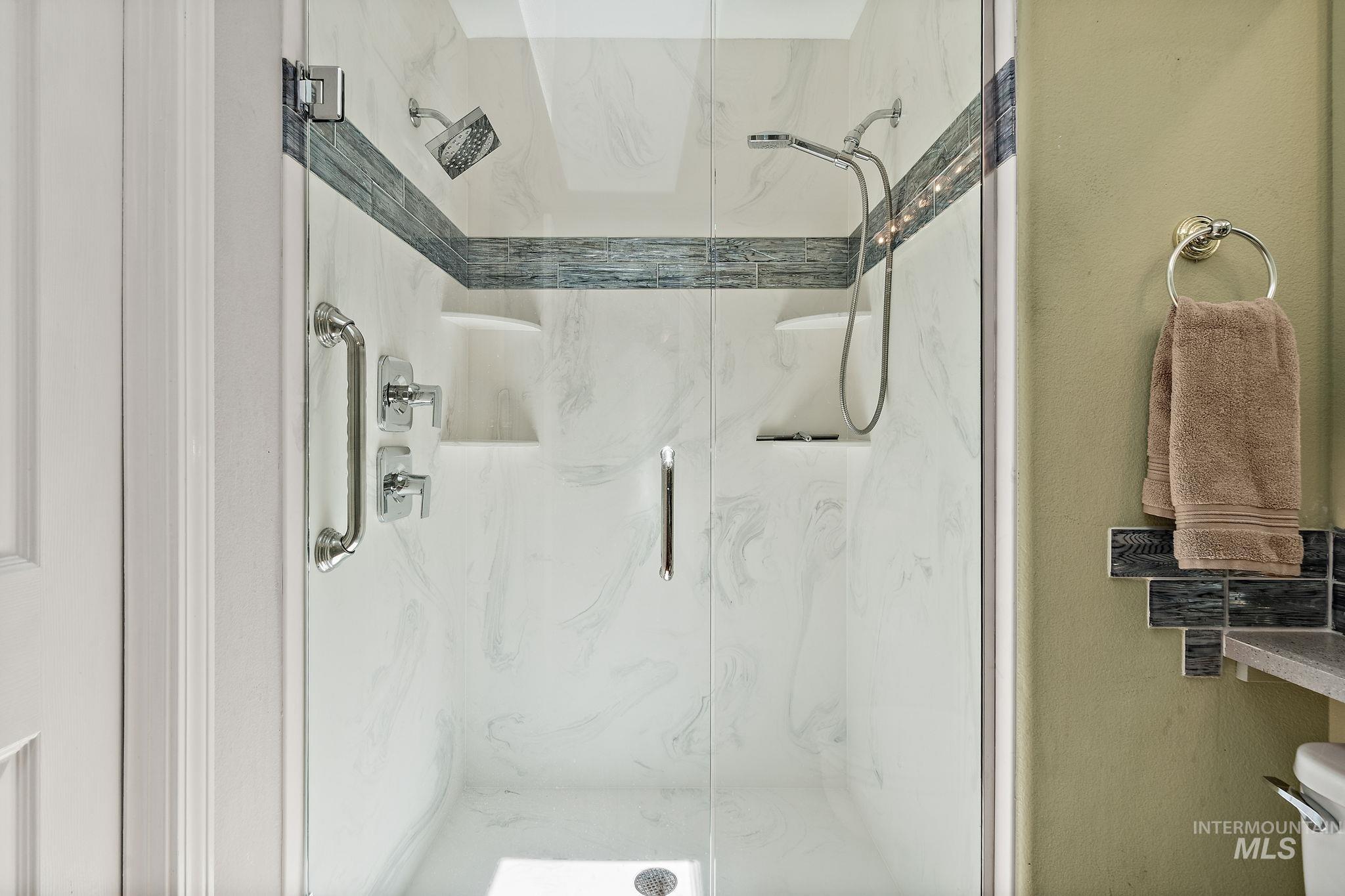 Full bathroom with a marble finish shower