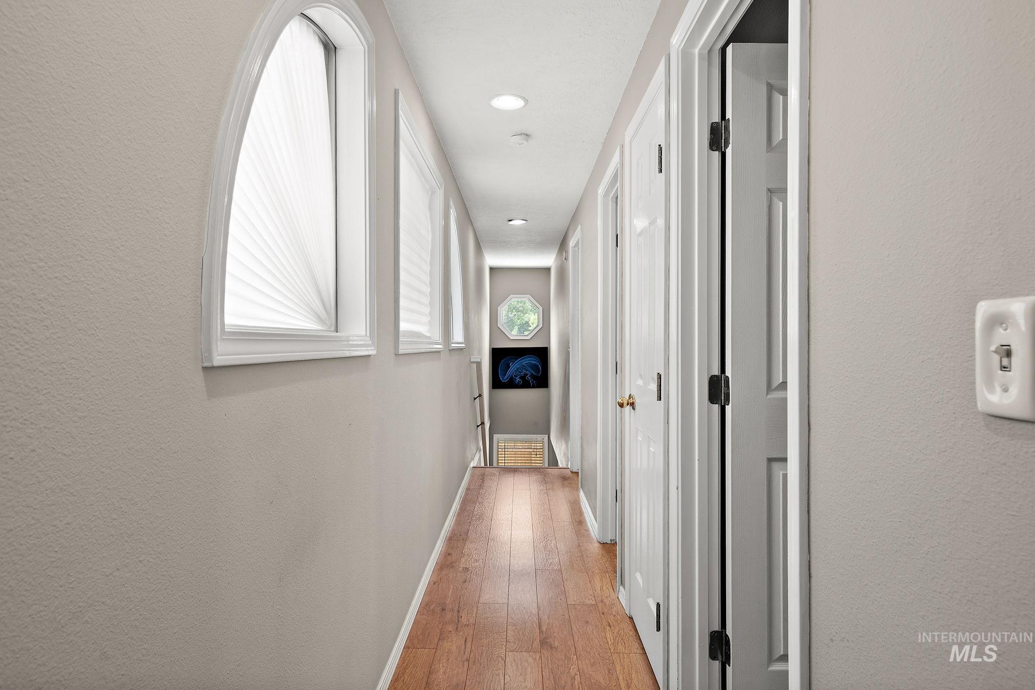 Hall featuring light wood-style floors and recessed lighting