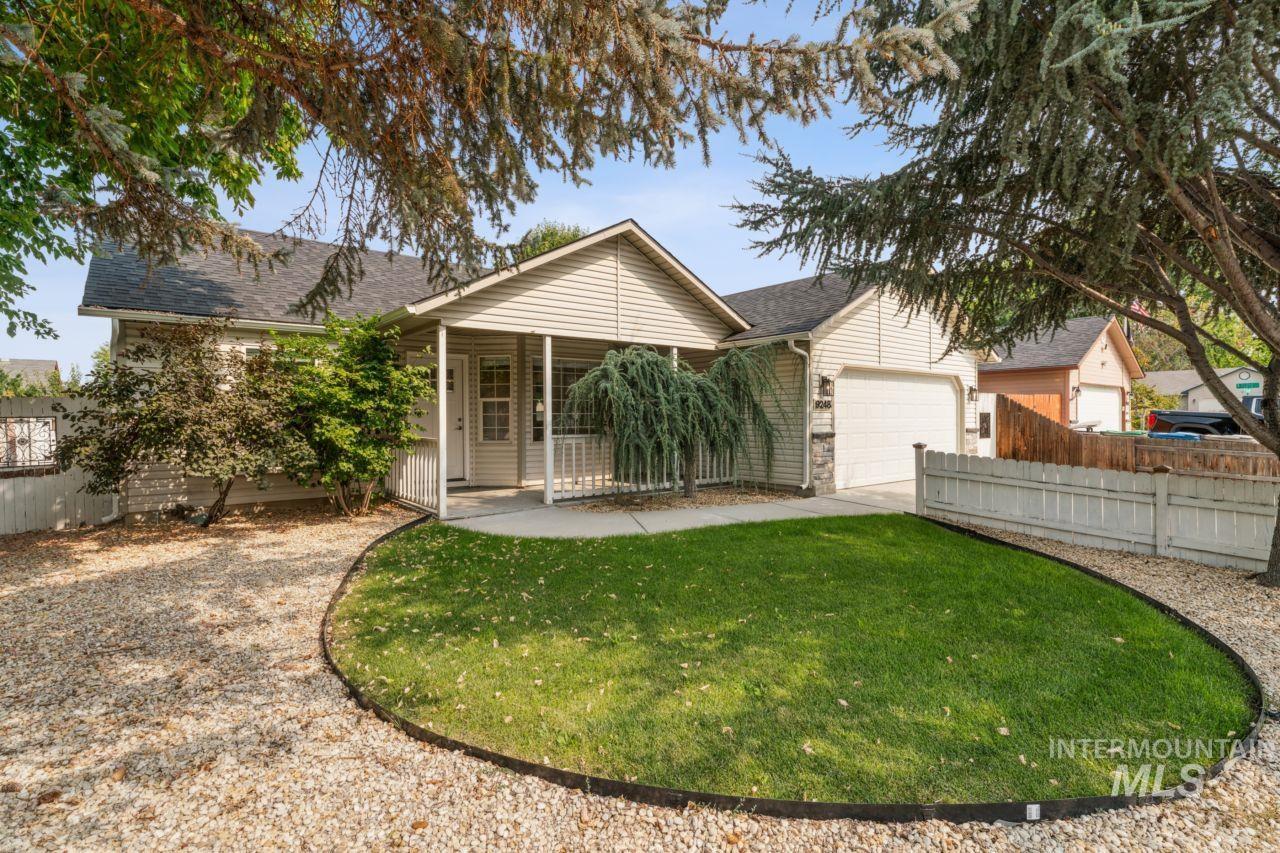 Single story home featuring roof with shingles, driveway, and an attached garage