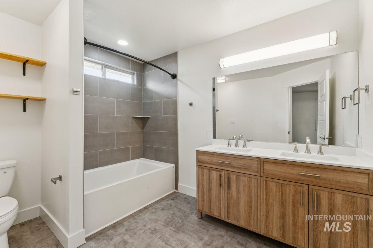 Bathroom with shower / bath combination and double vanity
