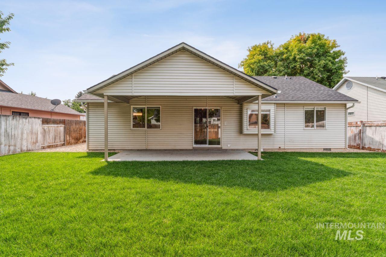 Back of house featuring a patio area and a shingled roof