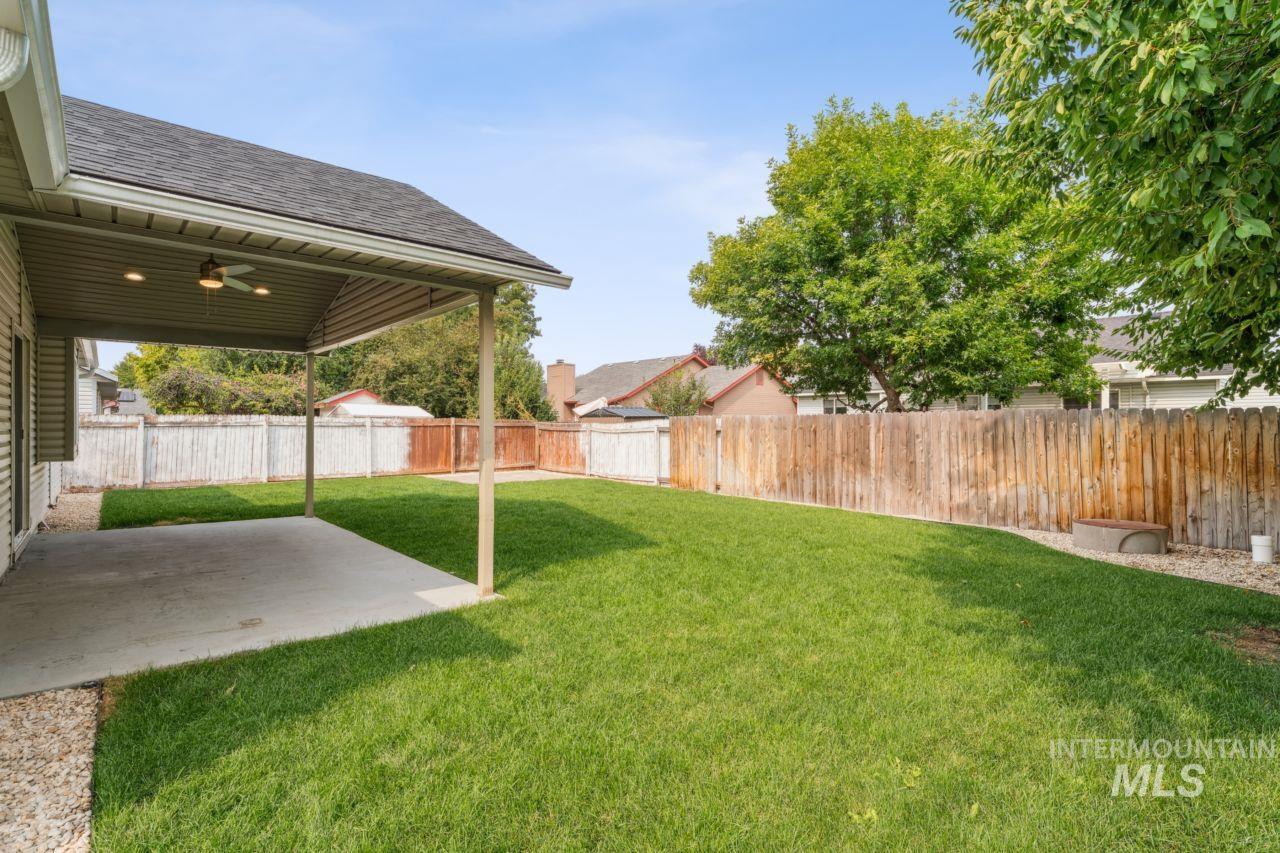 Fenced backyard with a patio
