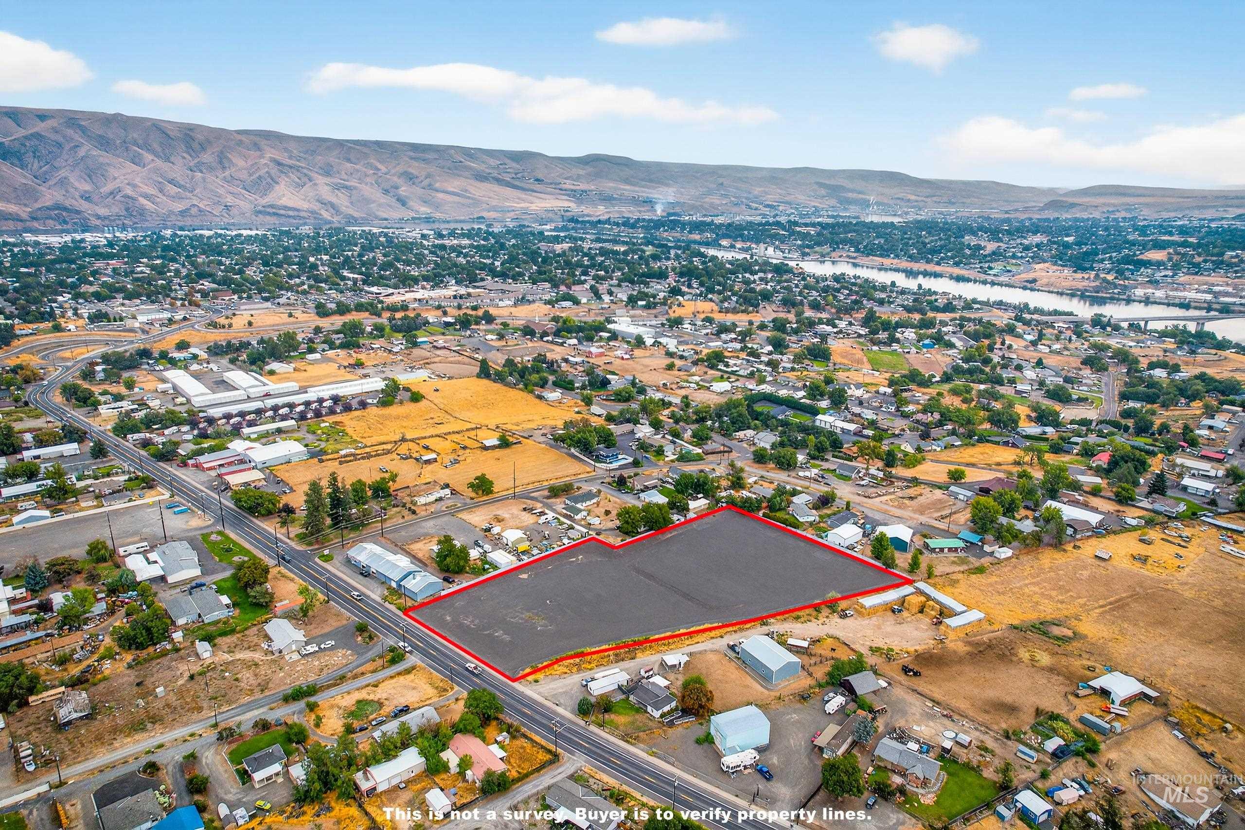 Aerial view of property's location featuring property parcel outlined and a water and mountain view