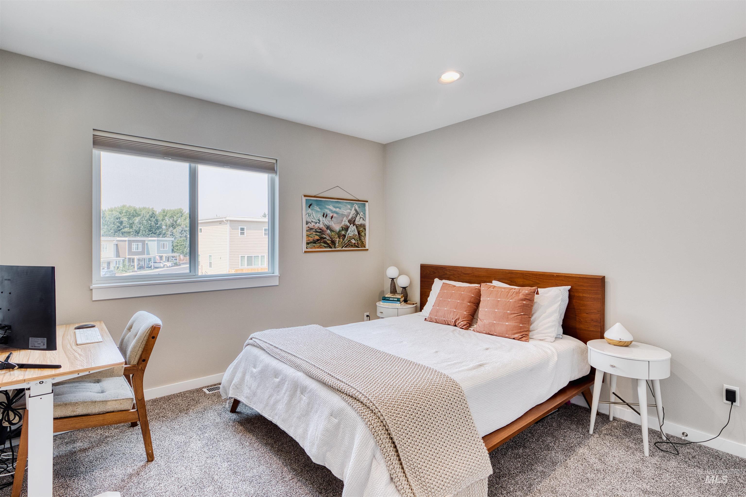 Bedroom with carpet, recessed lighting, and an office area