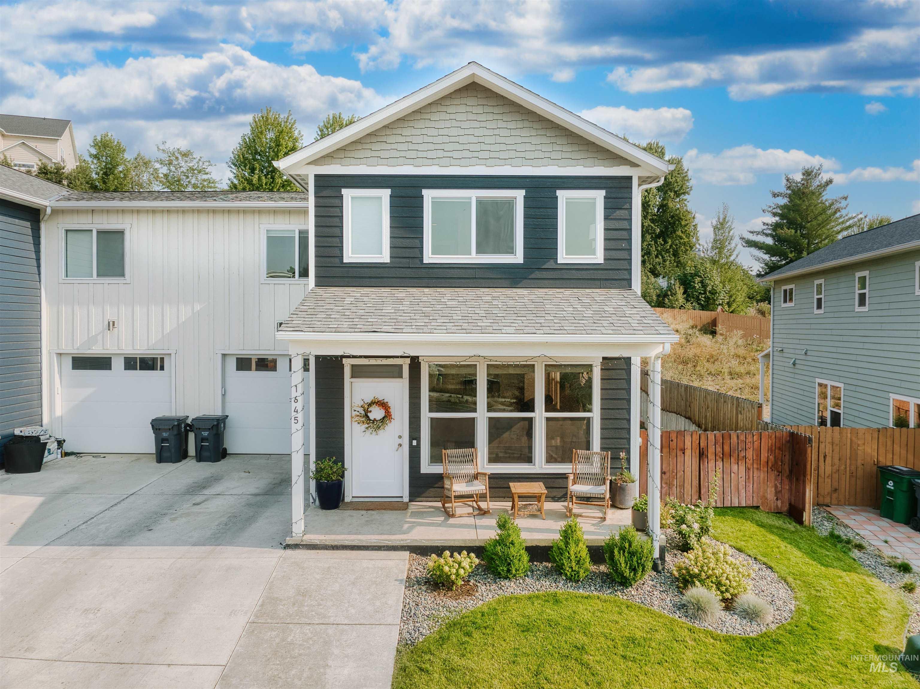 View of front facade with concrete driveway and a garage