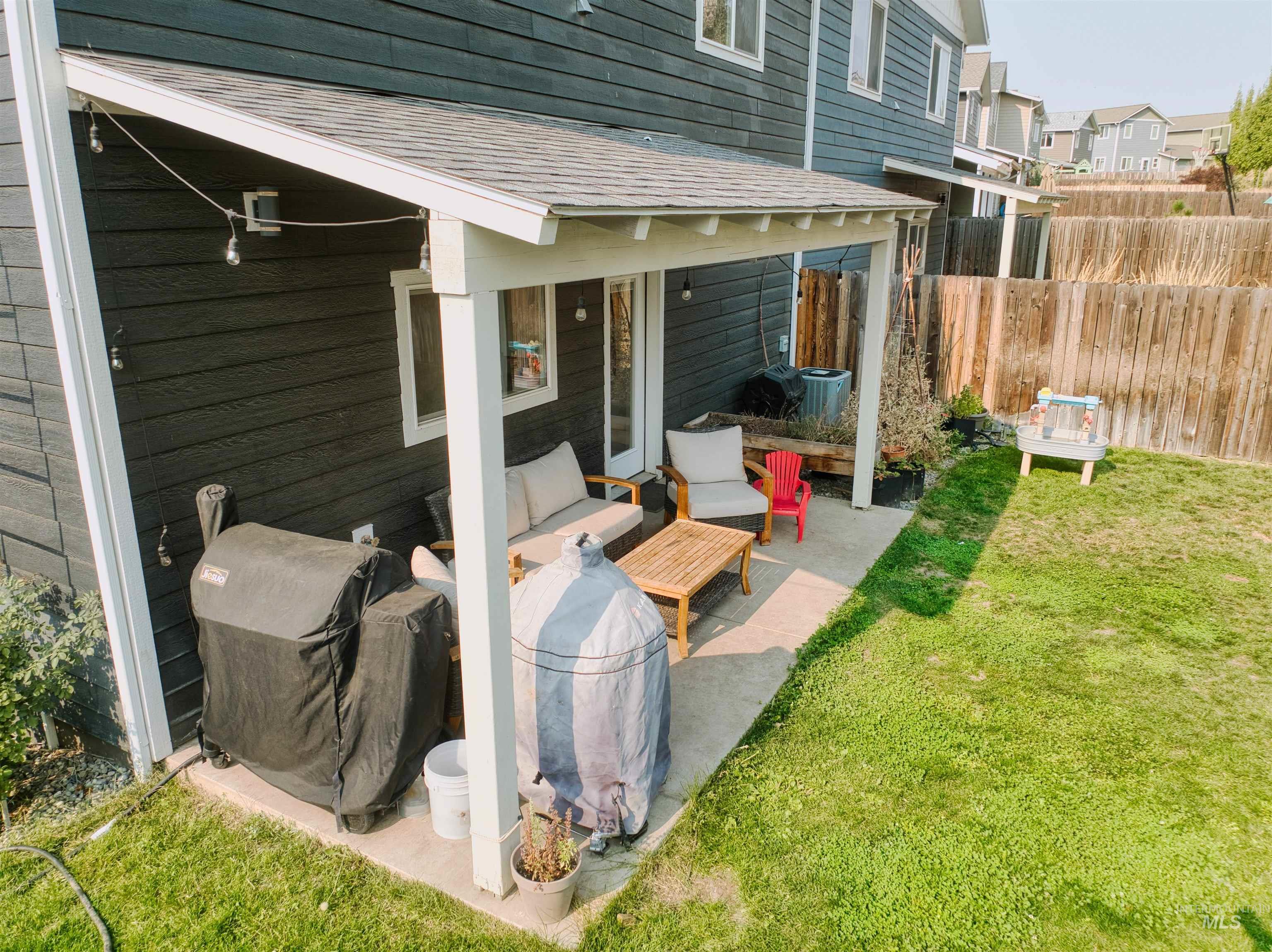 View of patio with a grill