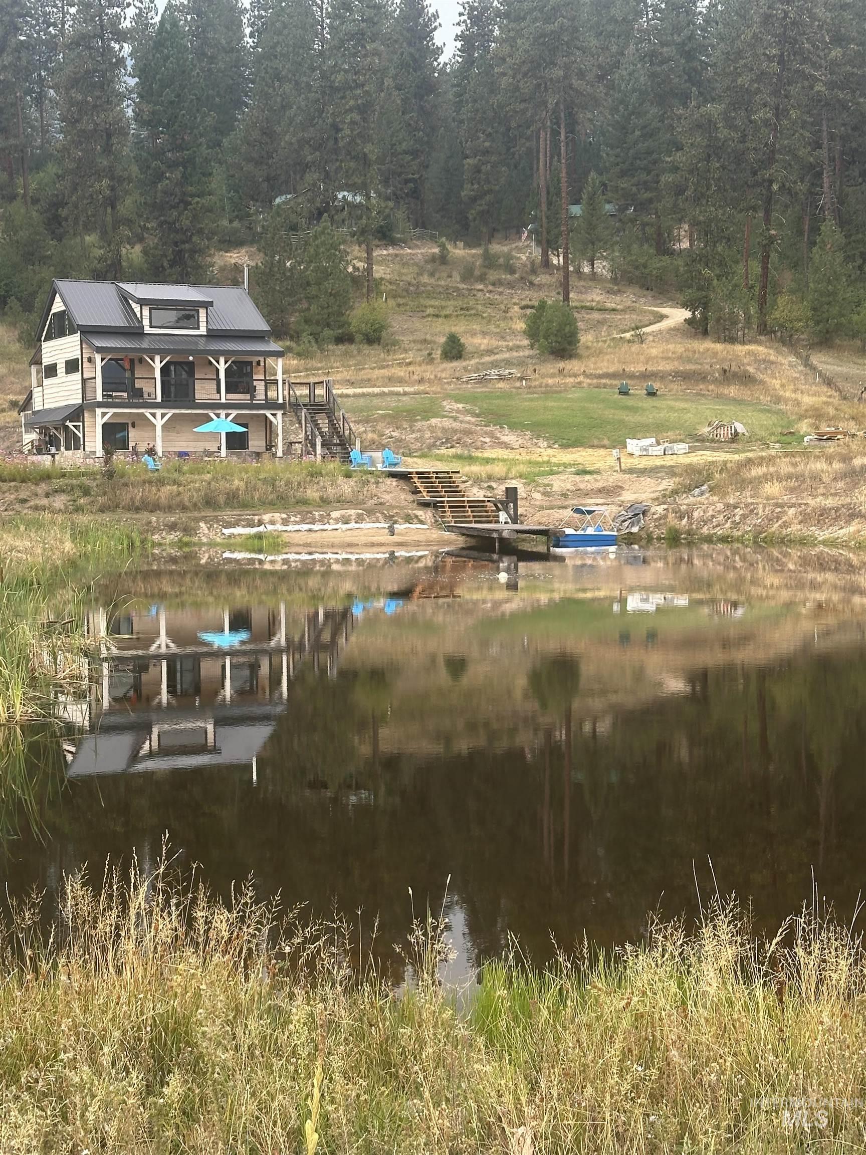 Back of house with a metal roof and a water view