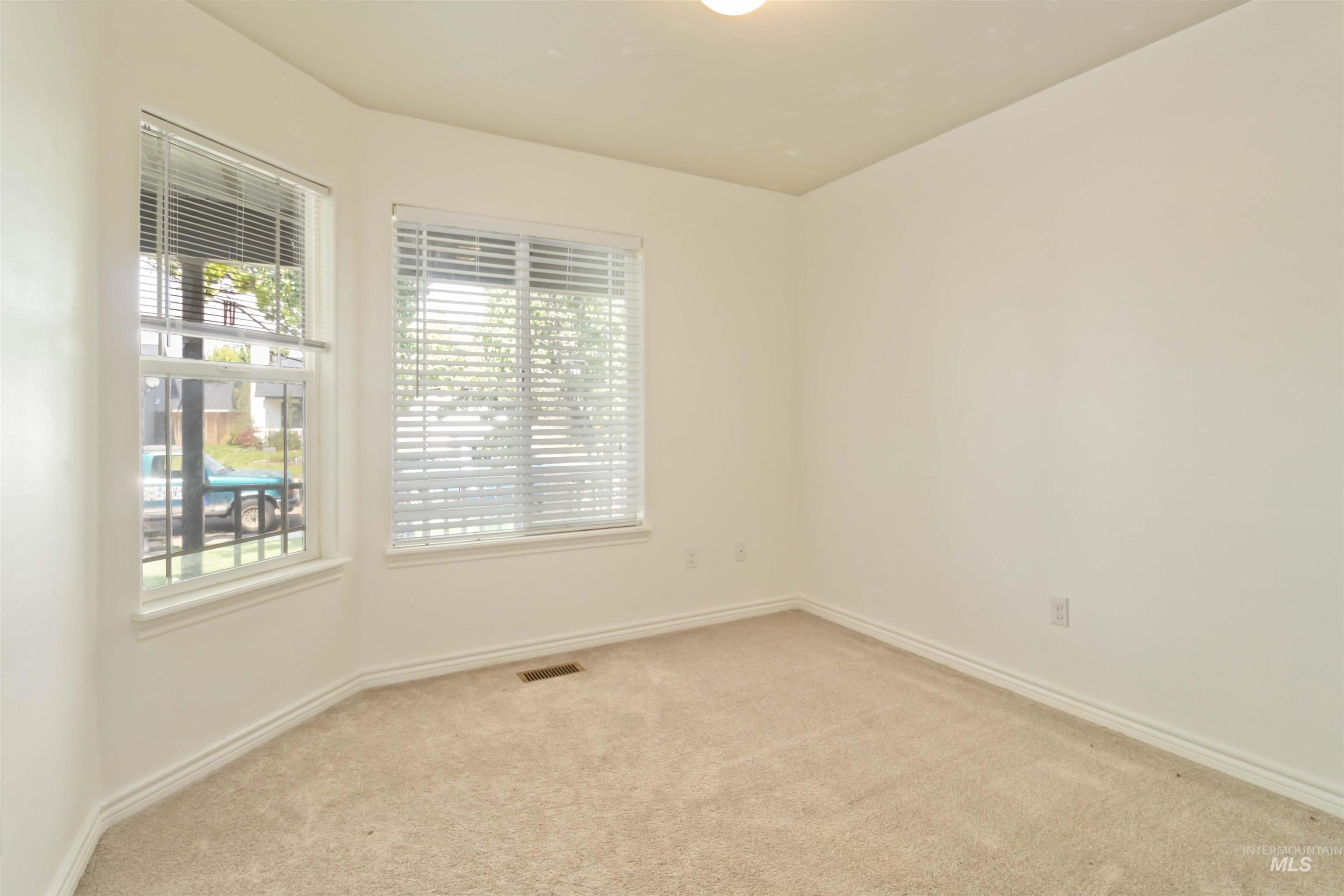 Carpeted empty room with plenty of natural light