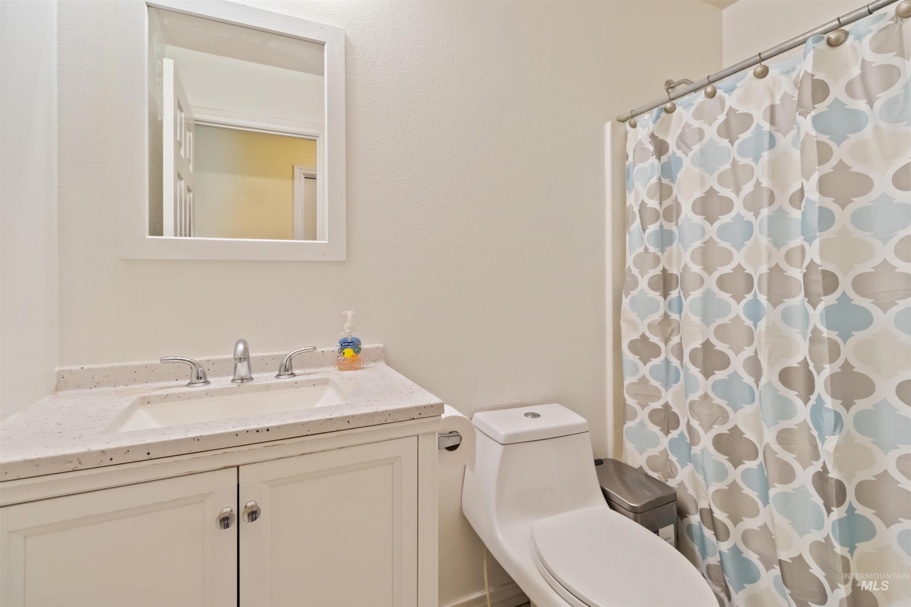 Bathroom with vanity and a shower with shower curtain