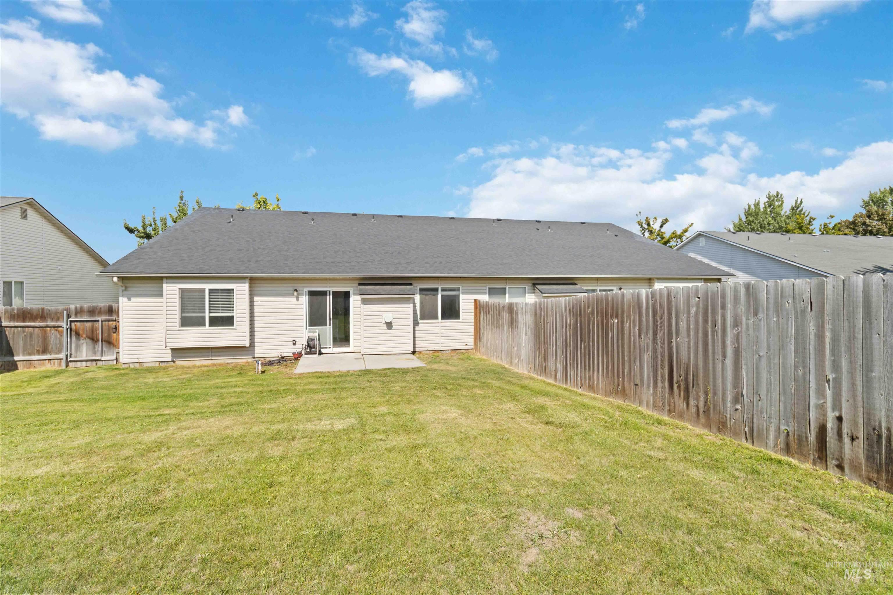 Rear view of property featuring a patio and a fenced backyard