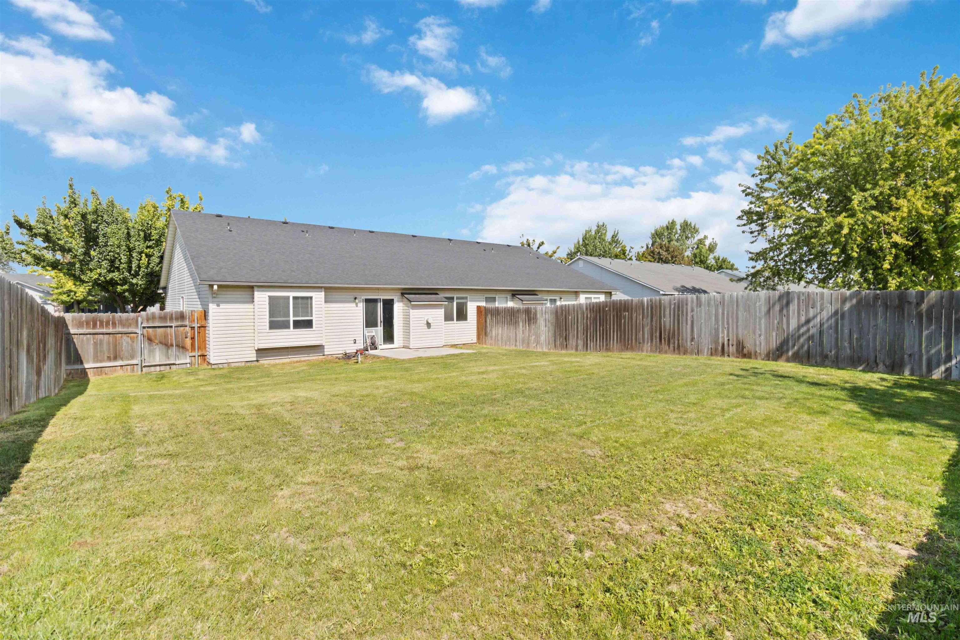 Rear view of property with a patio area and a fenced backyard
