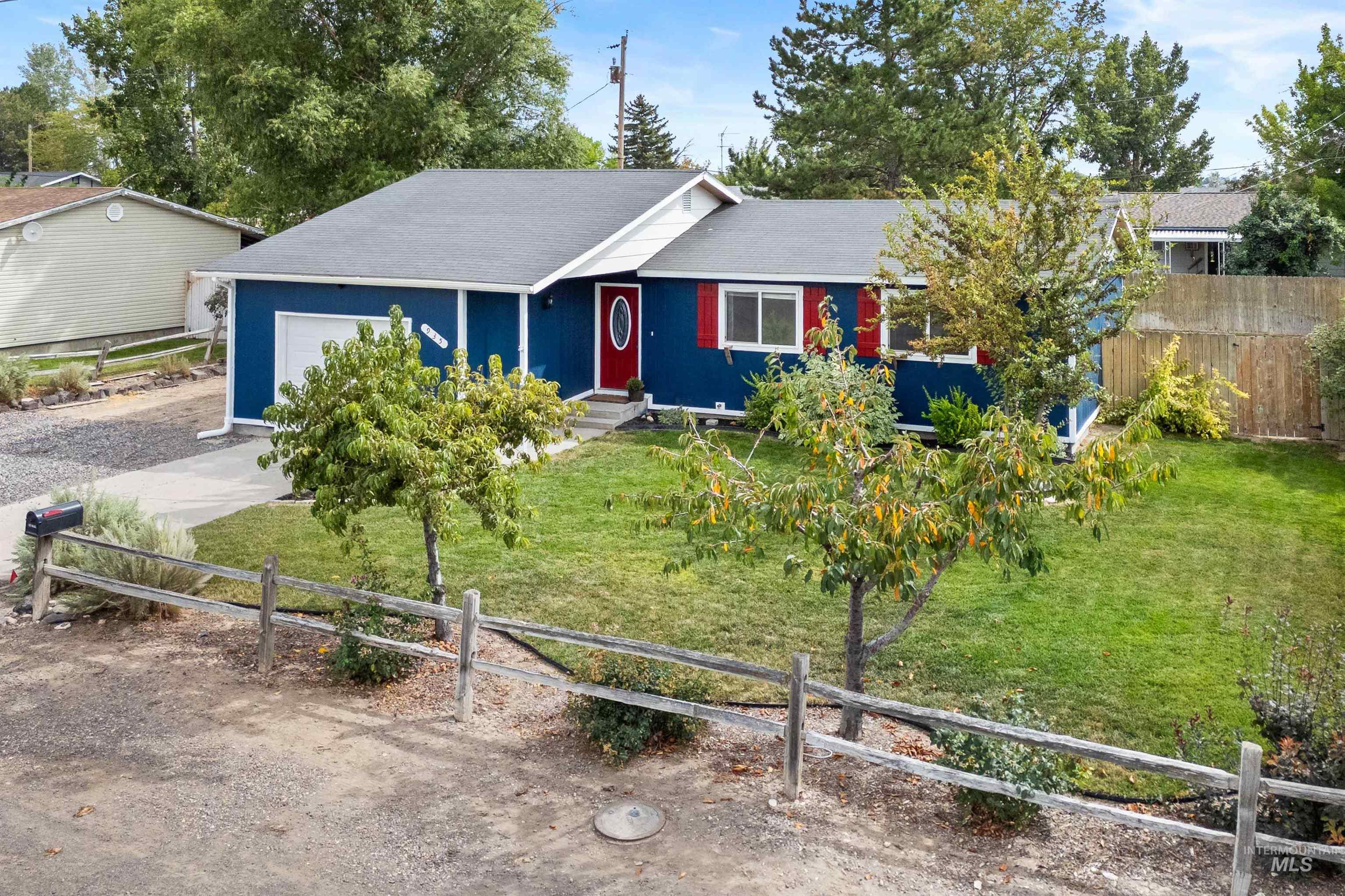 Single story home with an attached garage, a shingled roof, and driveway