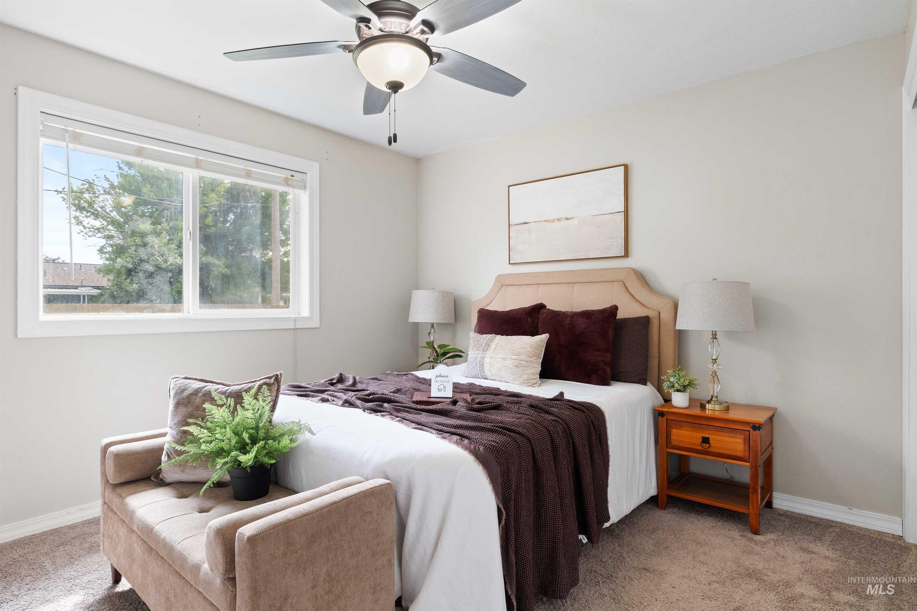 Carpeted bedroom with baseboards and a ceiling fan