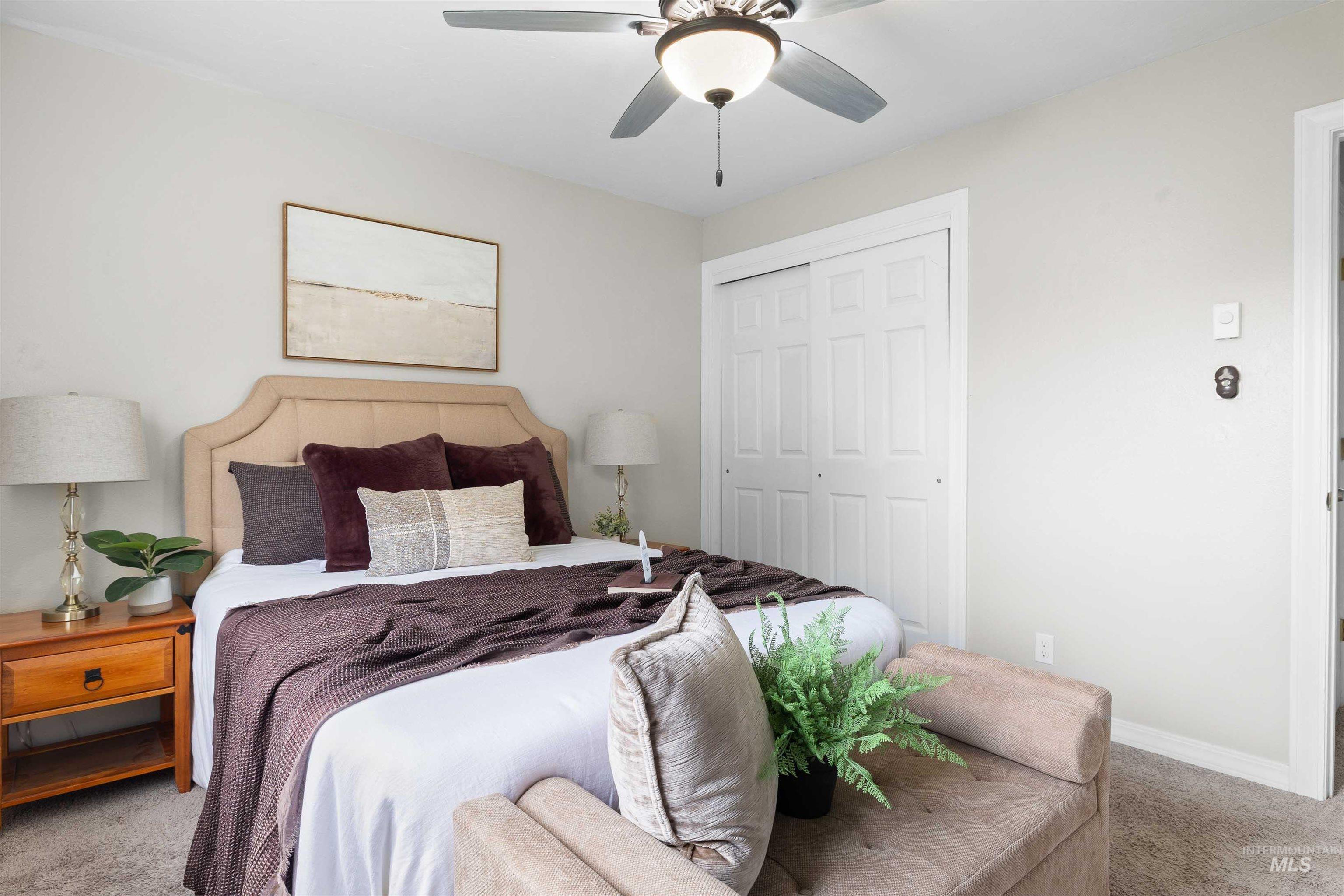 Bedroom with carpet, a closet, and ceiling fan
