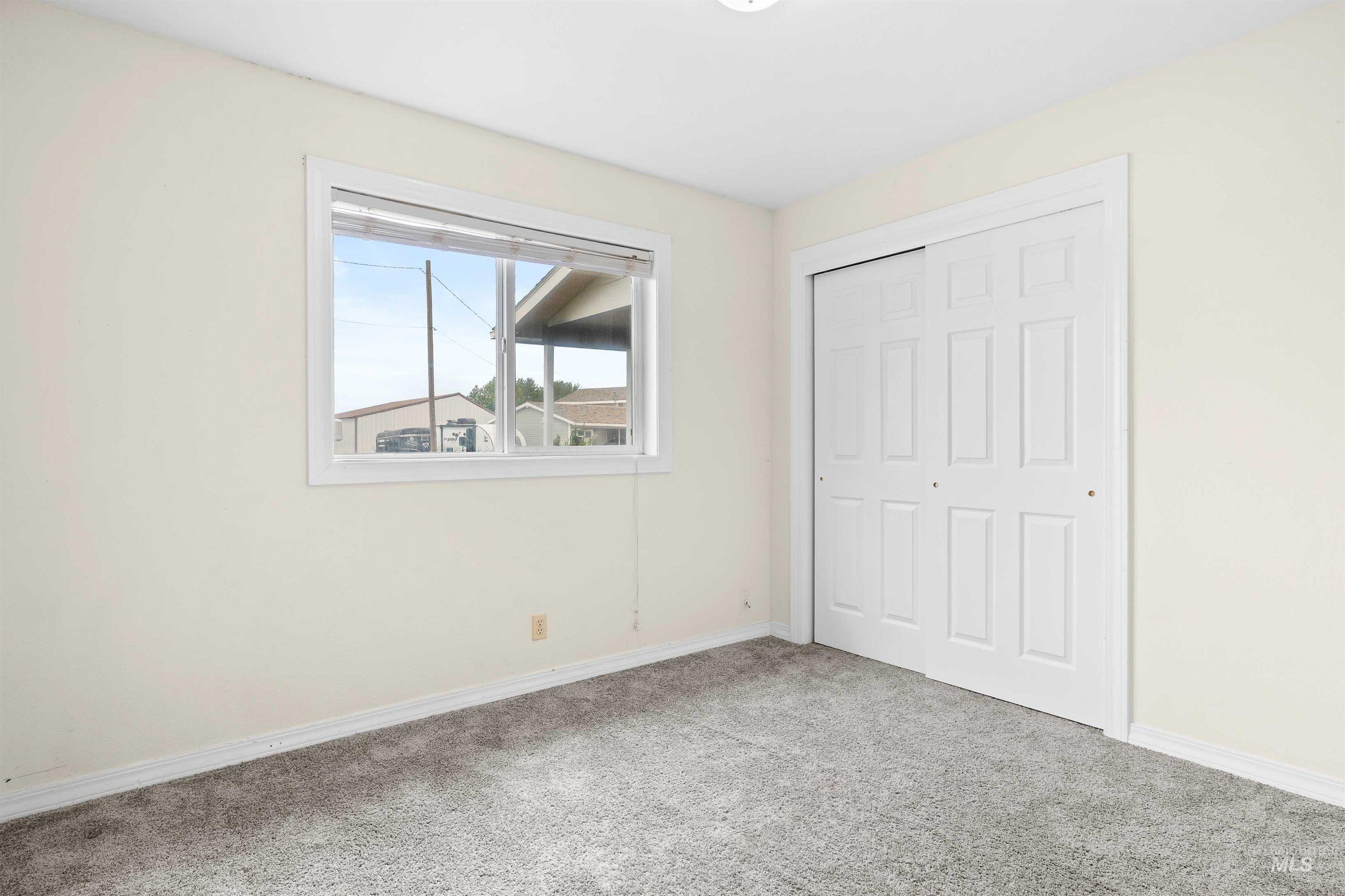 Unfurnished bedroom with carpet and a closet
