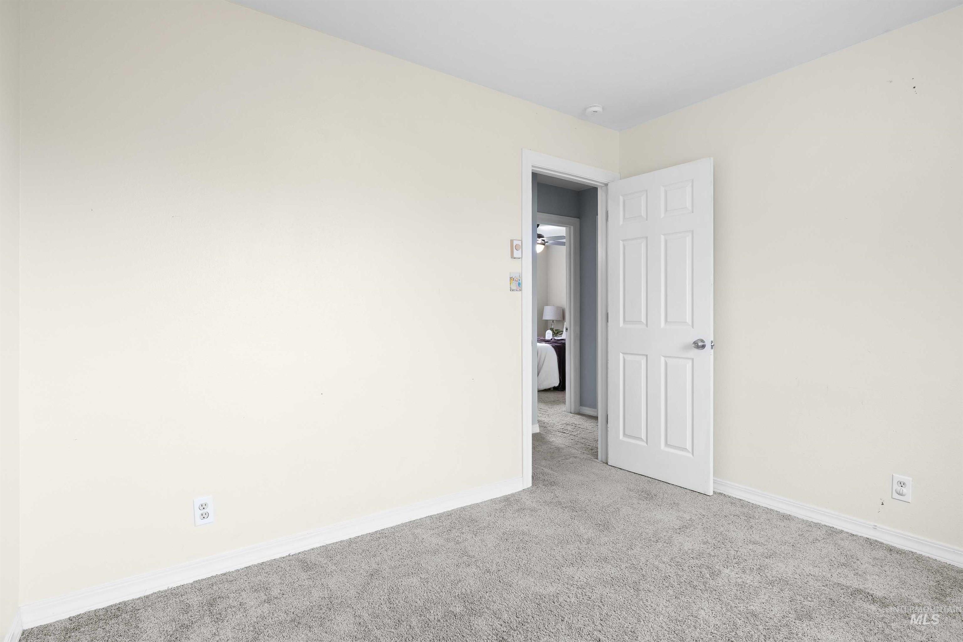 Carpeted spare room with baseboards