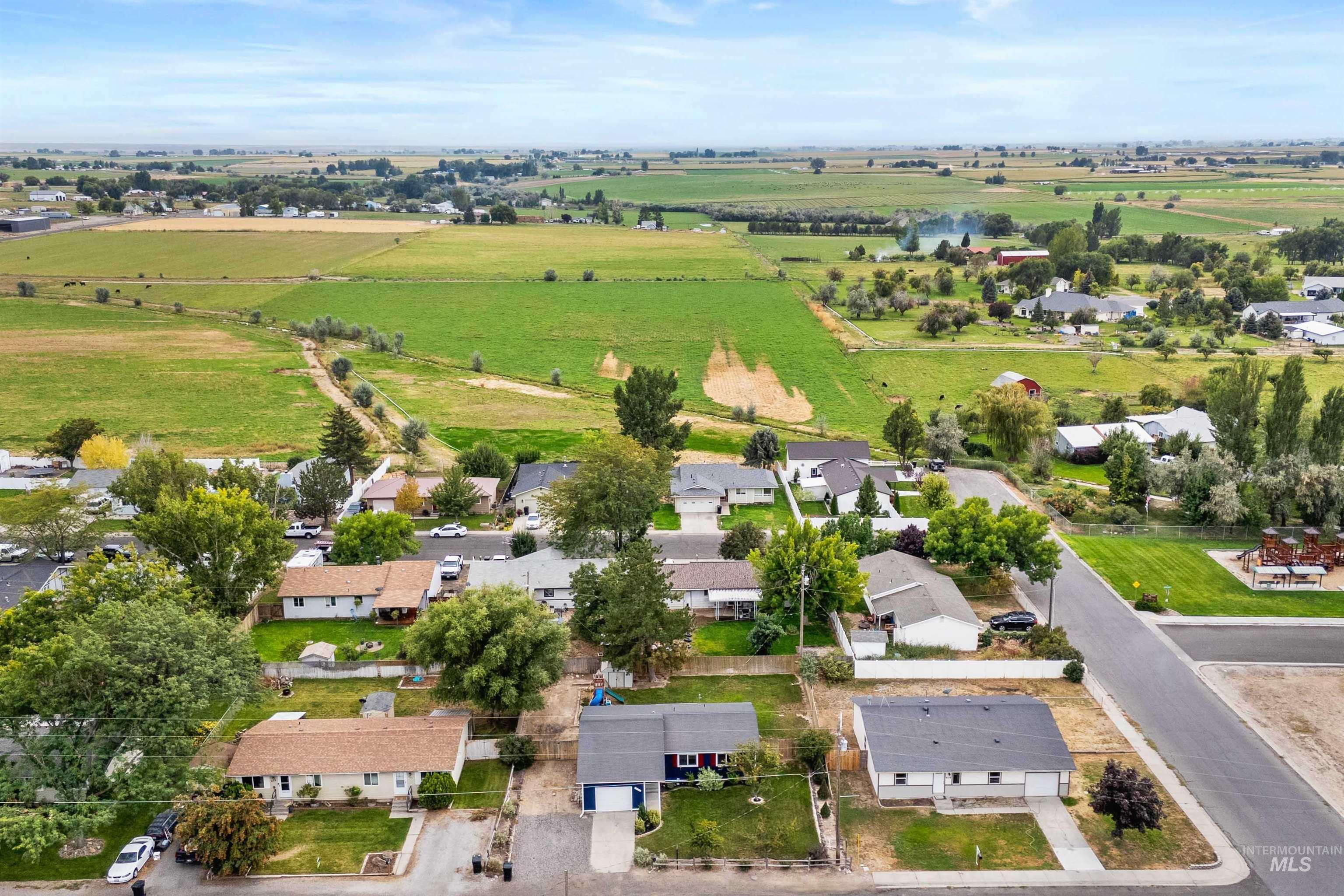 Aerial view of sparsely populated area featuring nearby suburban area