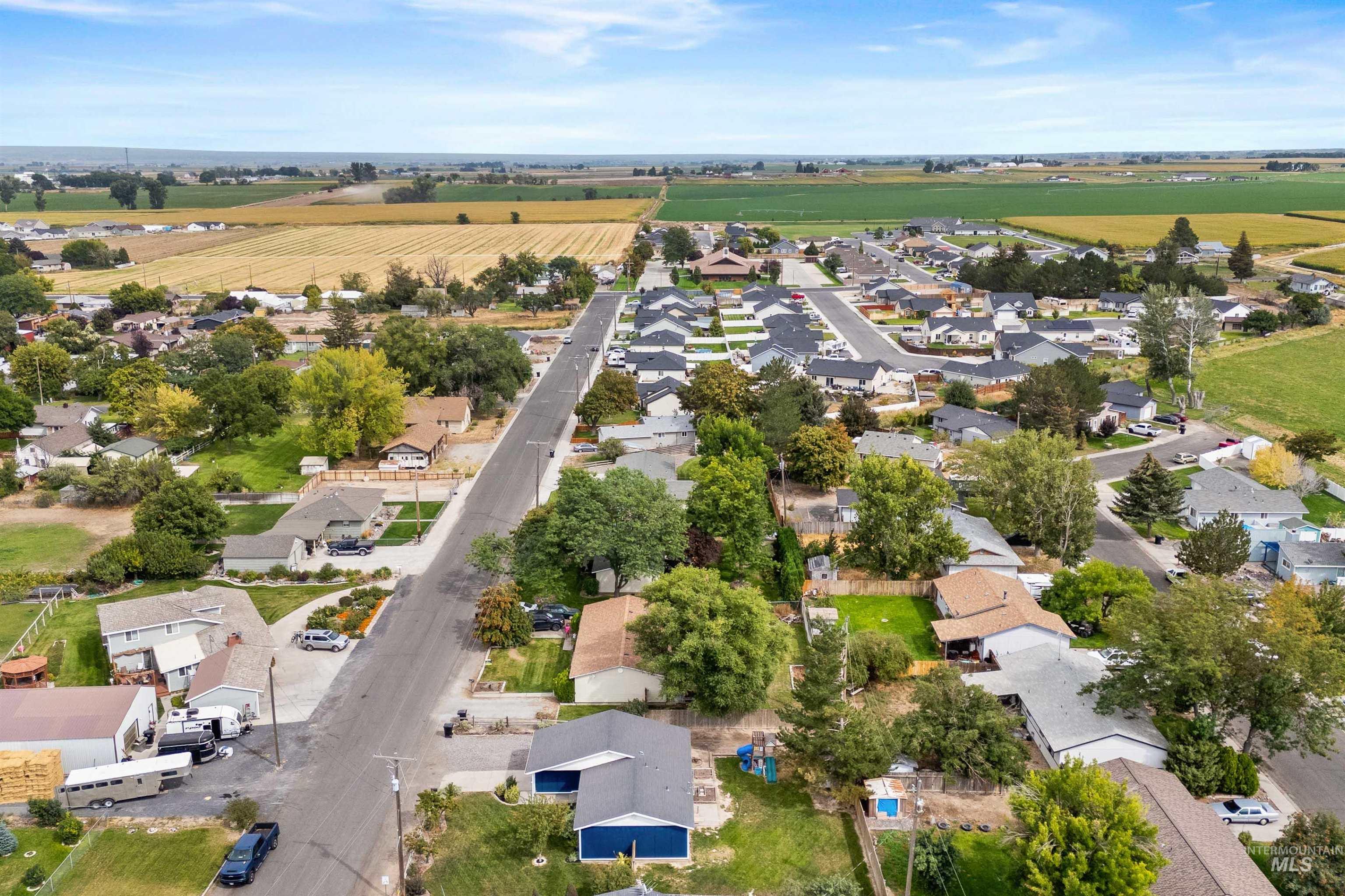 Aerial view of sparsely populated area with nearby suburban area and farmland