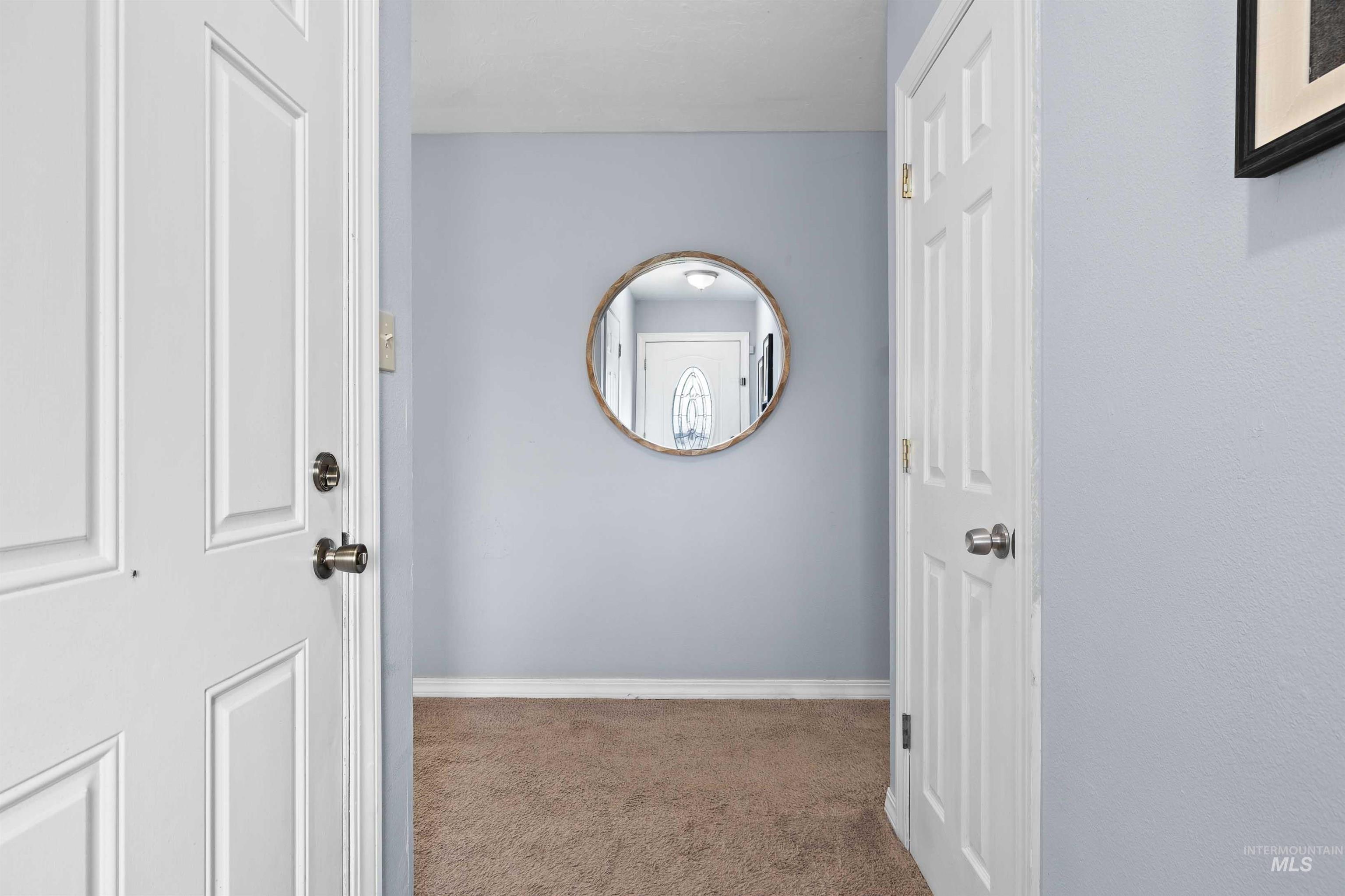 Hall with carpet flooring and baseboards