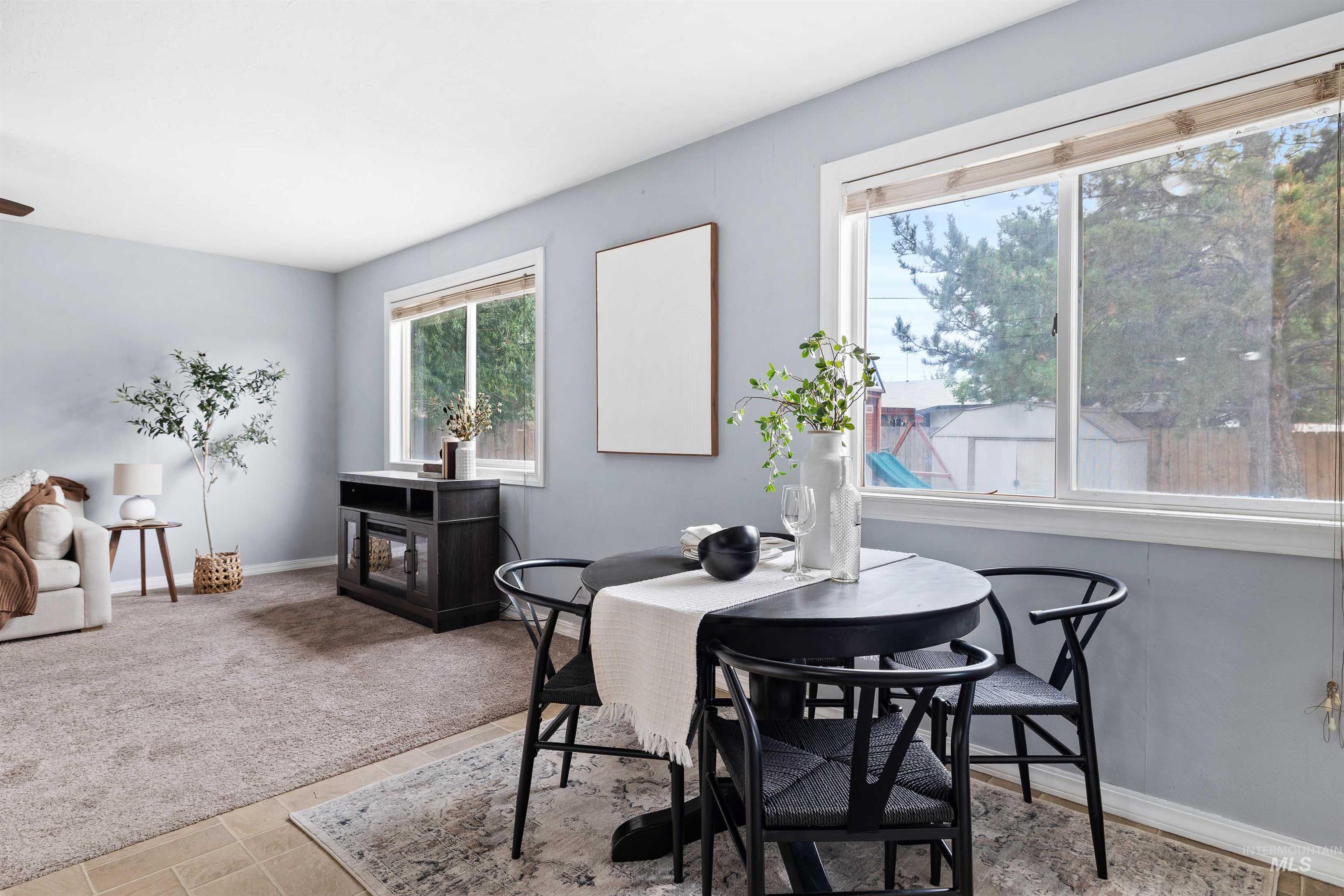 Dining room with baseboards and light colored carpet