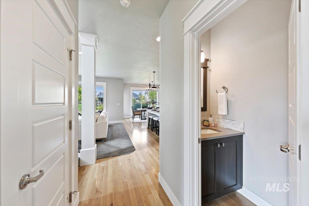 Hall featuring light wood-style floors and a textured ceiling