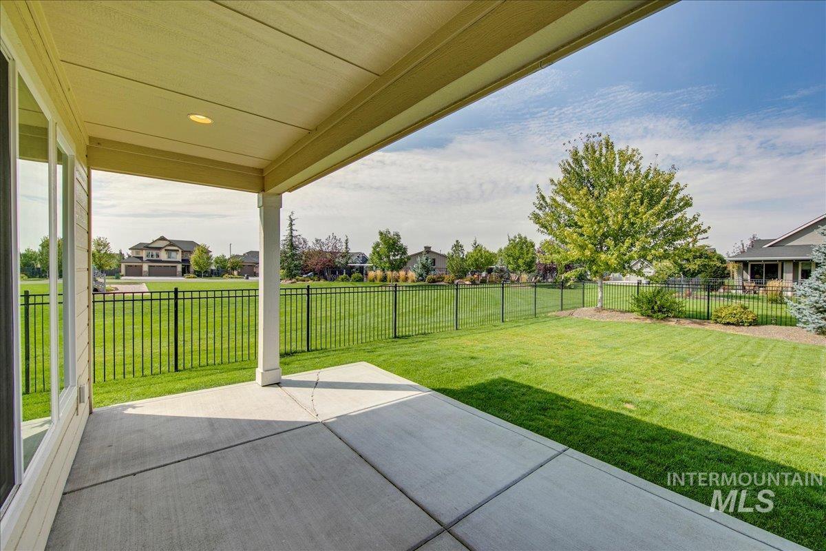 Fenced backyard featuring a patio area and a residential view