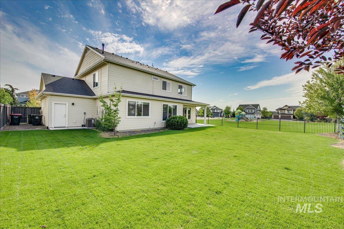 Back of house with a fenced backyard and a patio area