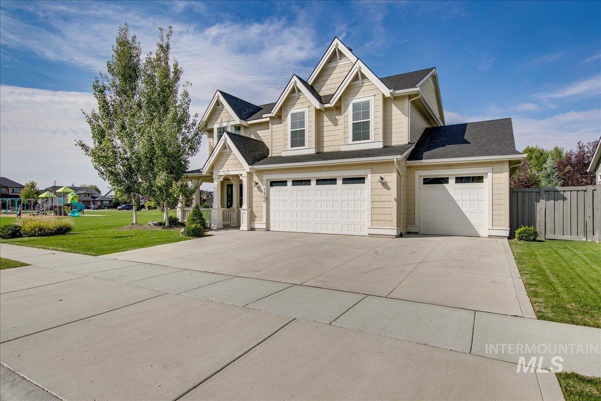 View of front of property featuring concrete driveway, an attached garage, and roof with shingles