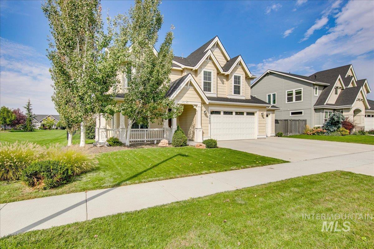 View of front of home featuring a porch, a garage, concrete driveway, and a residential view