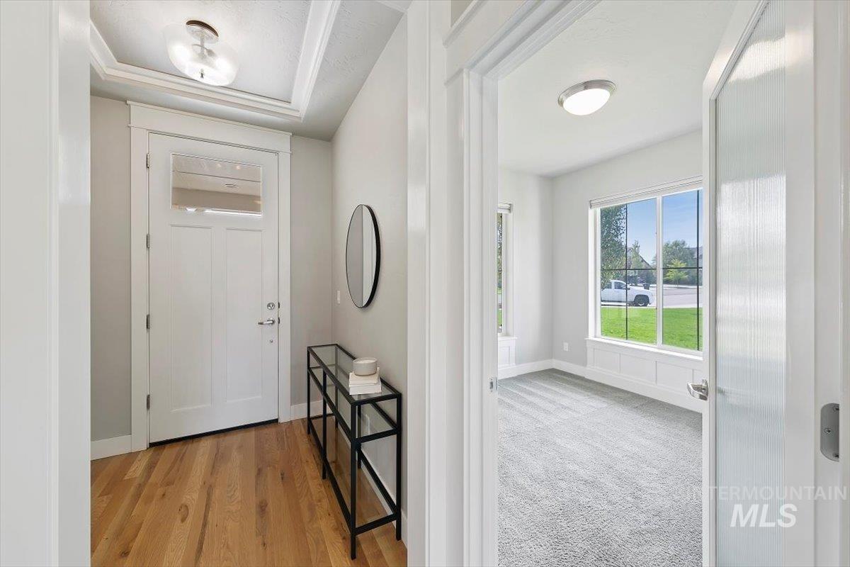 Foyer entrance featuring light wood-style flooring and light carpet